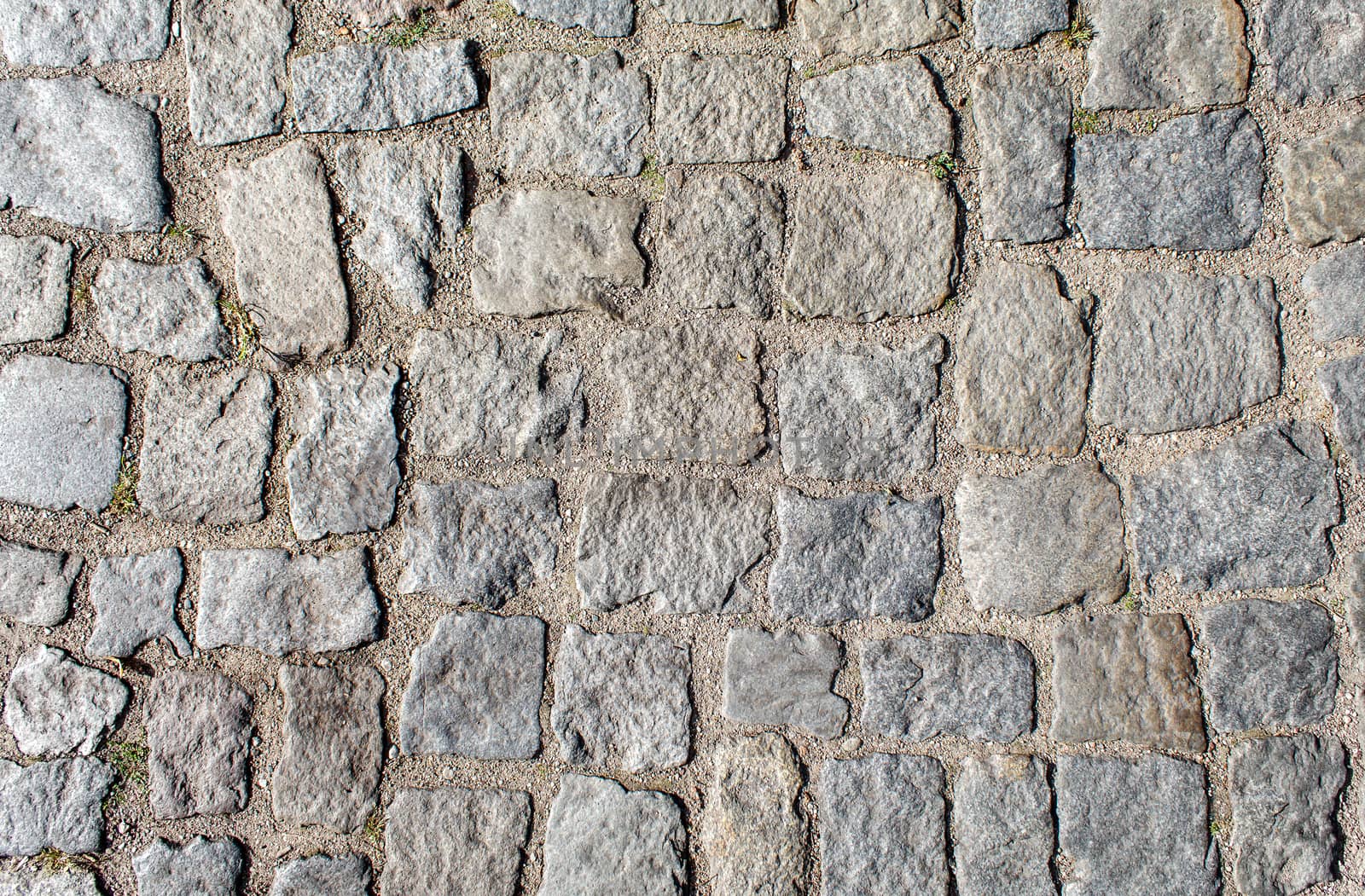 pavement of granite stone.old cobblestone road pavement texture. absrtact background. outdoor closeup