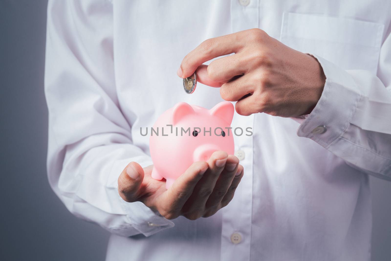 Hand of kid holding coin put in piggy bank with money stack growing growth saving money, Concept invesment for financial freedom plan, business deposit to hope success