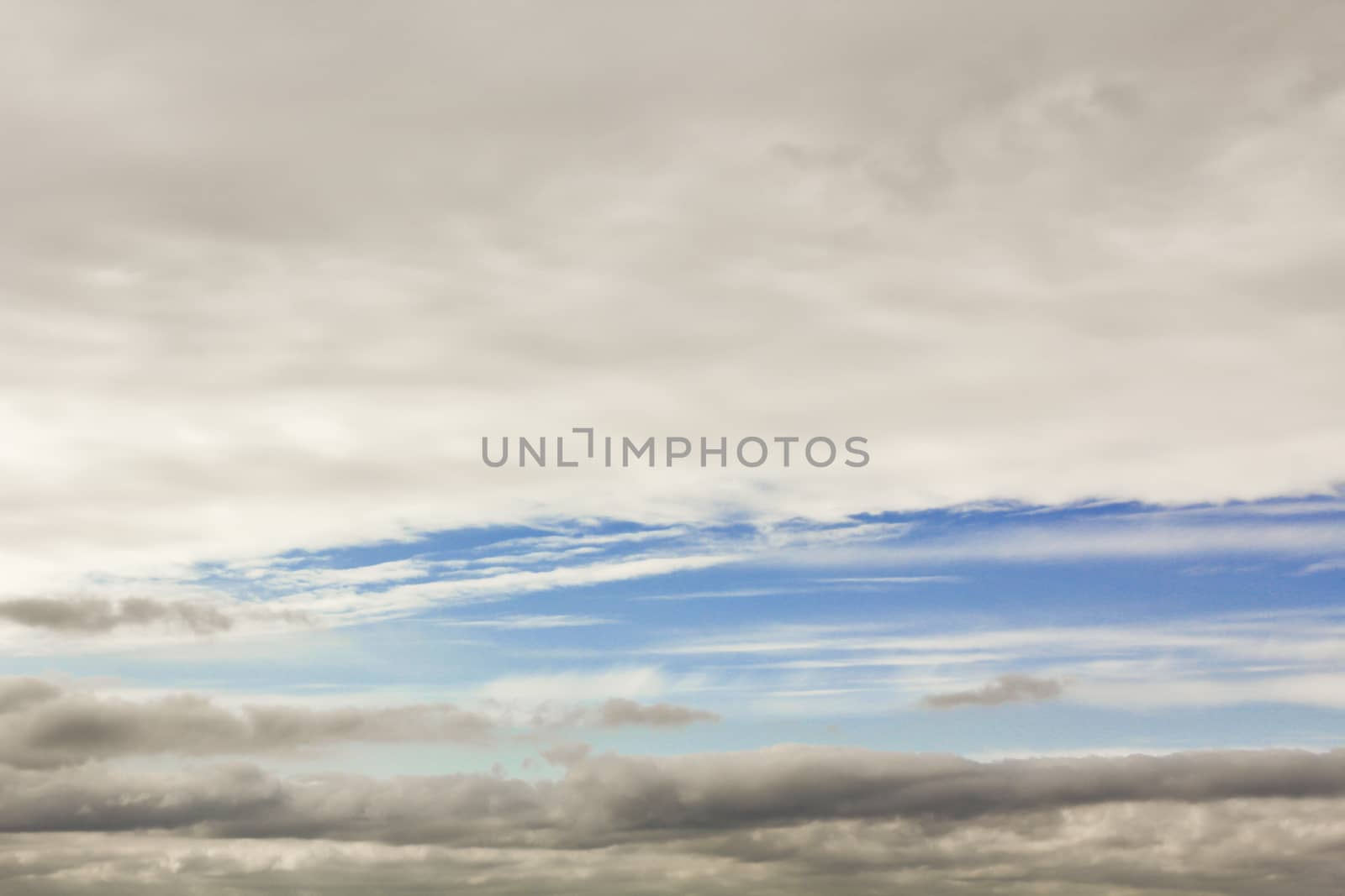 Blue streak in the cloudy sky. Sky panorama, Germany. by Arkadij