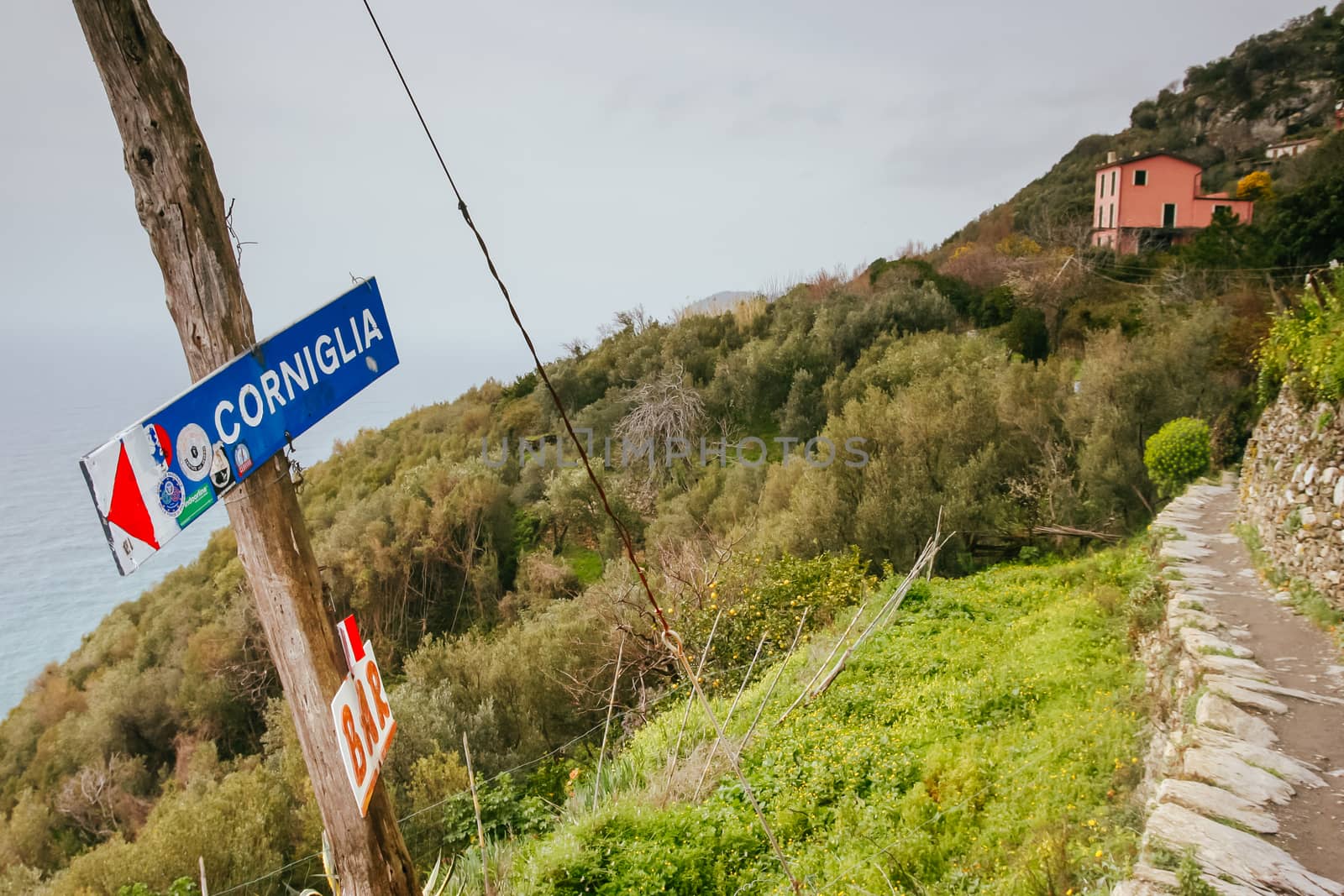 Signpost on the famous walking path linking the five towns, pointing to the town of Corniglia in the Cinque Terre, Italy
