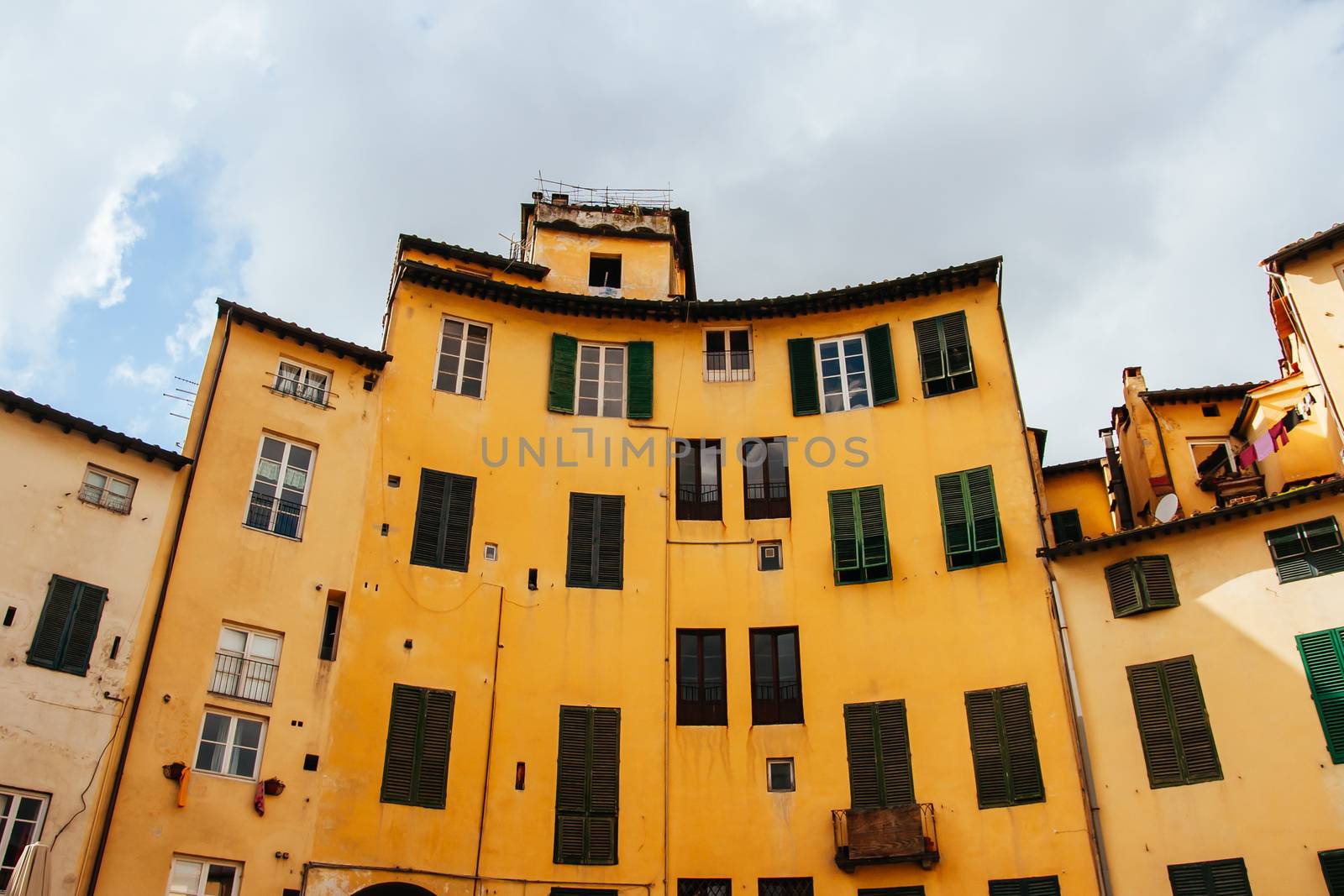 Beautiful historic architecture of Piazza dell'Anfiteatro in old town Lucca Italy on a cool winter's evening