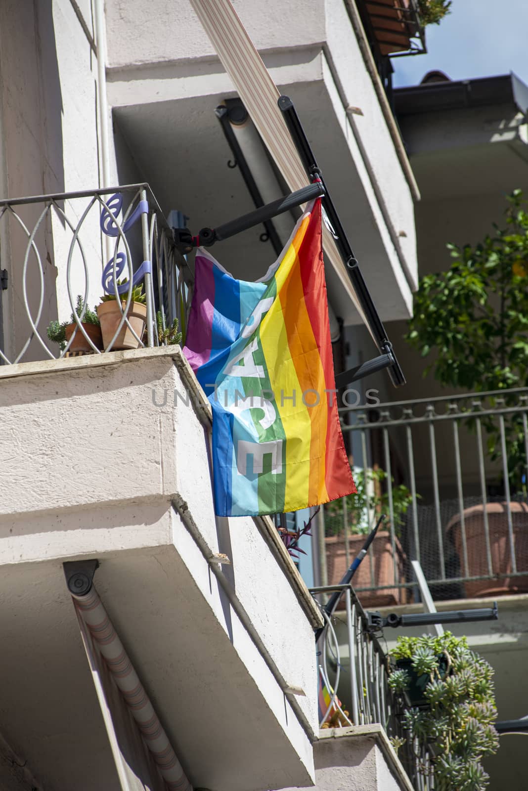 peace flag placed on a balcony of a house by carfedeph