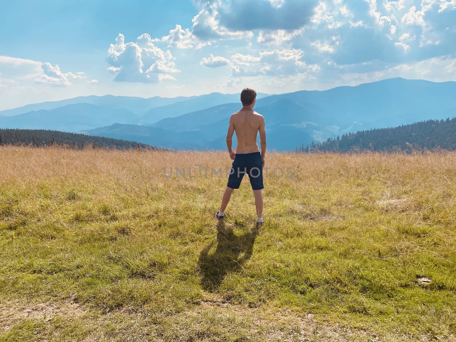 happy young man with arms raised