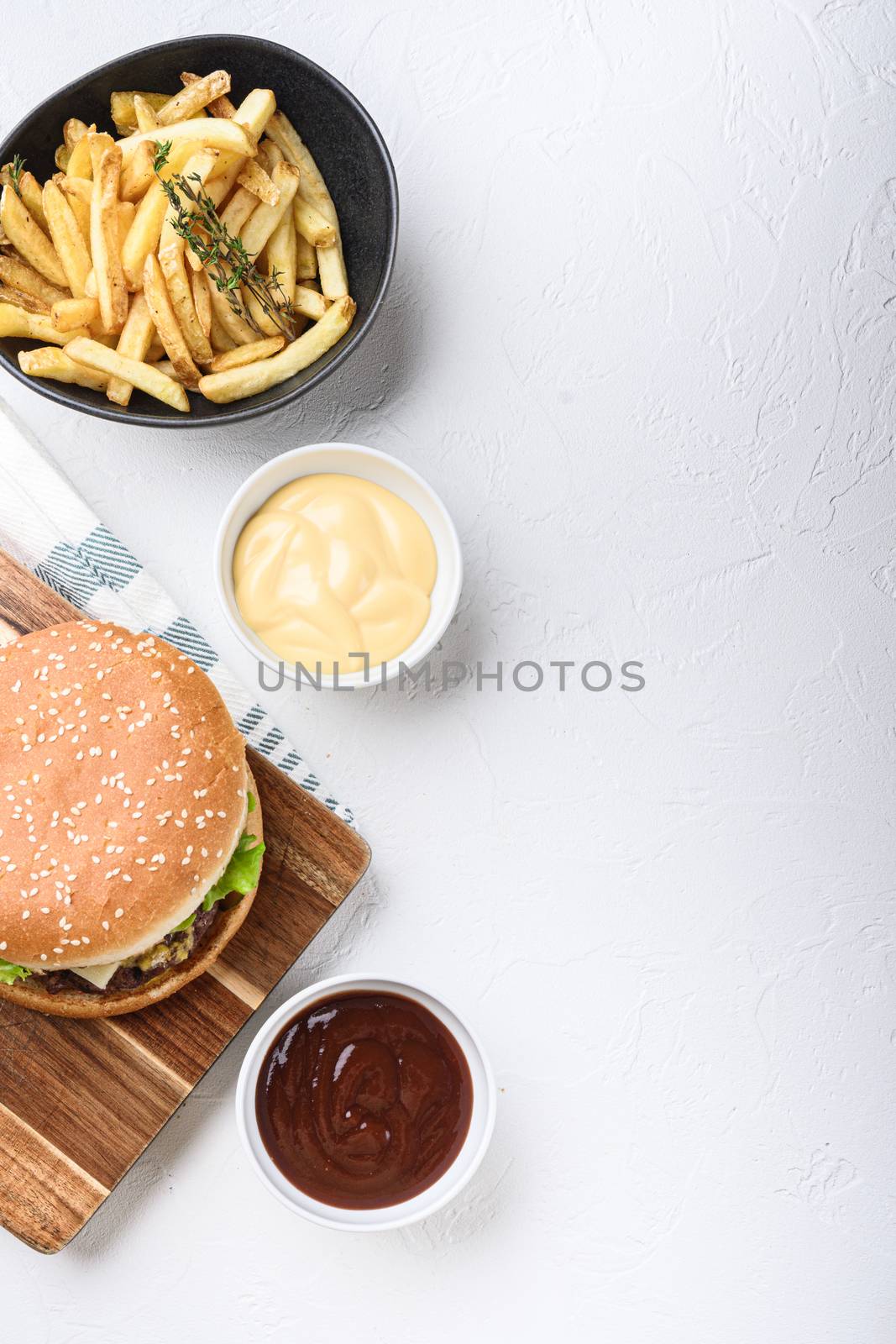 Ground beef burger and french fries on white background with copy space by Ilianesolenyi