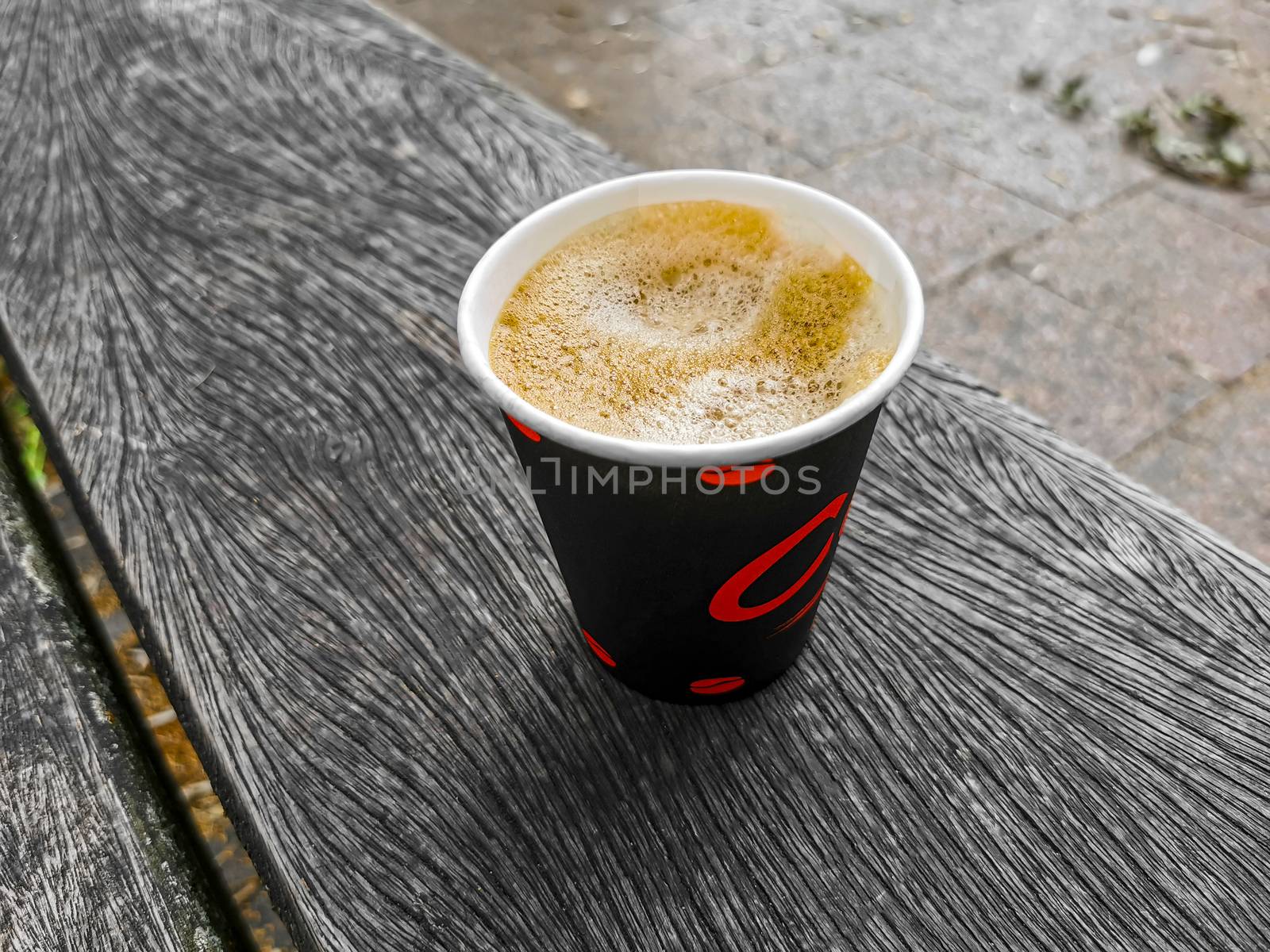 Red paper cup with coffee to go. Leherheide, Bremerhaven. by Arkadij