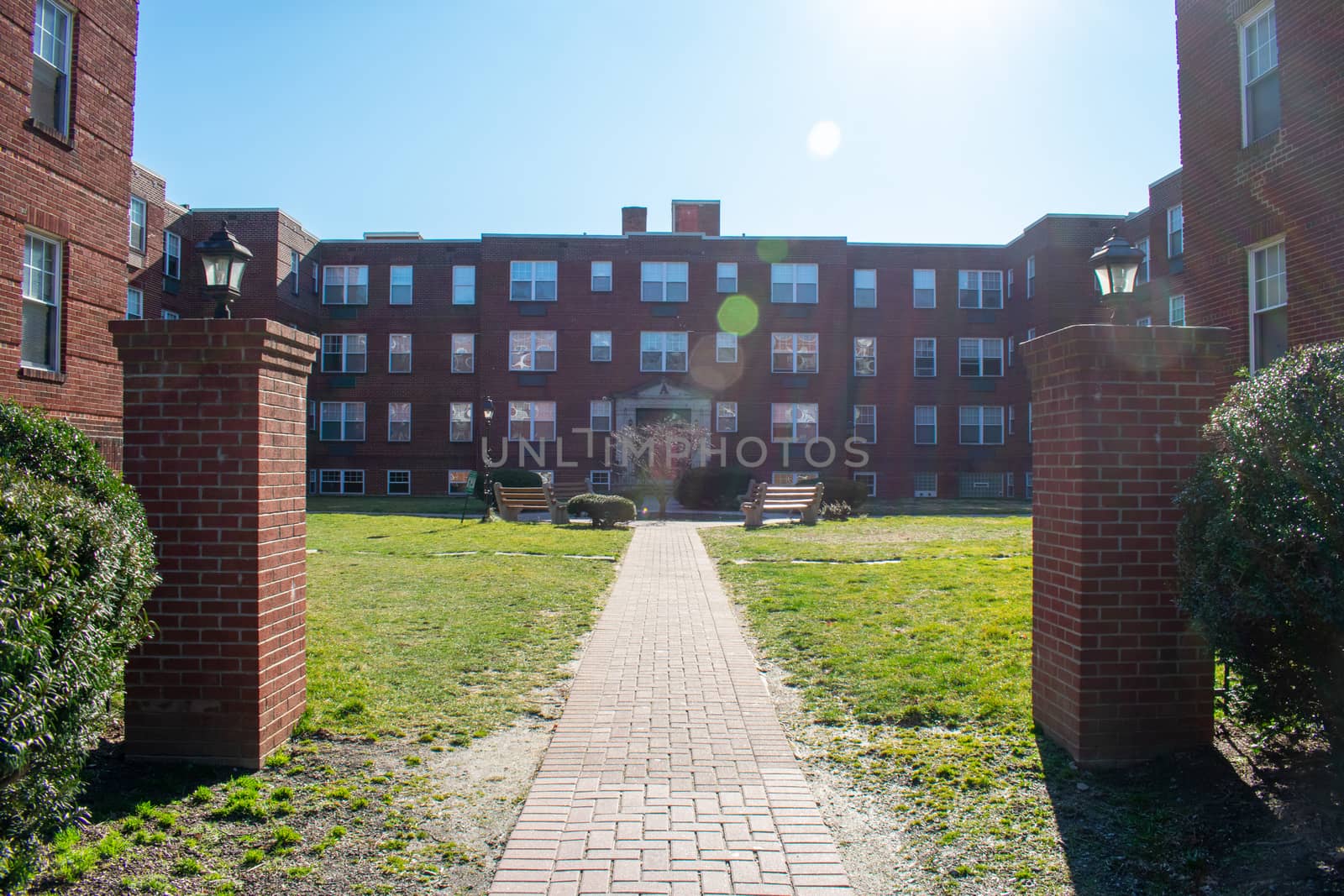 The Courtyard of a Brick Apartment Building on a Sunny Day