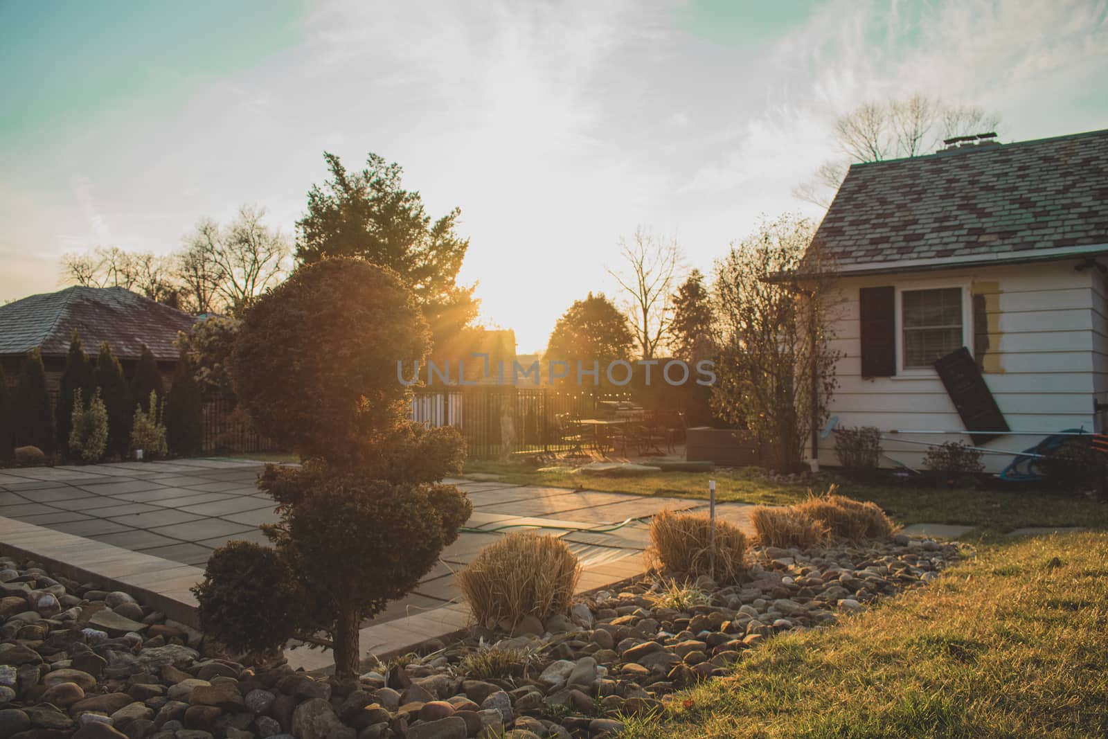 A Bright Orange Sunset in a Suburban Backyard by bju12290