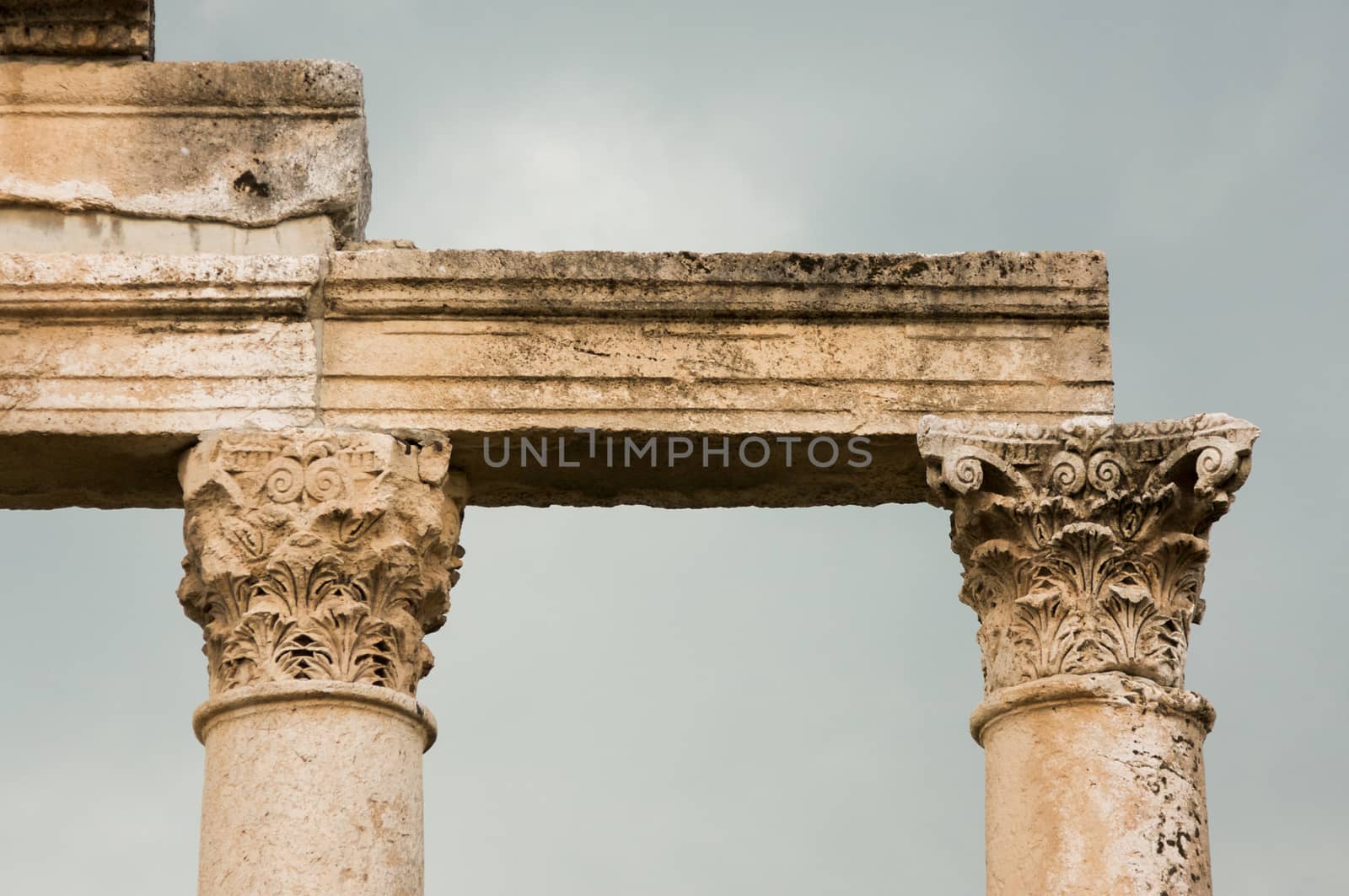 Apamea, Syria - May, 2009: Syria before the war. the Great Colonnade and triumphal arches in the impressive Apamea Greek and Roman city of Apamea in Syria. . Column tops the Corinthian order is the most ornate of the Greek orders, column having an ornate capital decorated with two rows of acanthus leaves.The site includes the famous Great Colonnade, one of the longest in the world. Because civil war in Syria that started in 2011 the Apamea ruins have been damaged and looted by treasure hunters.