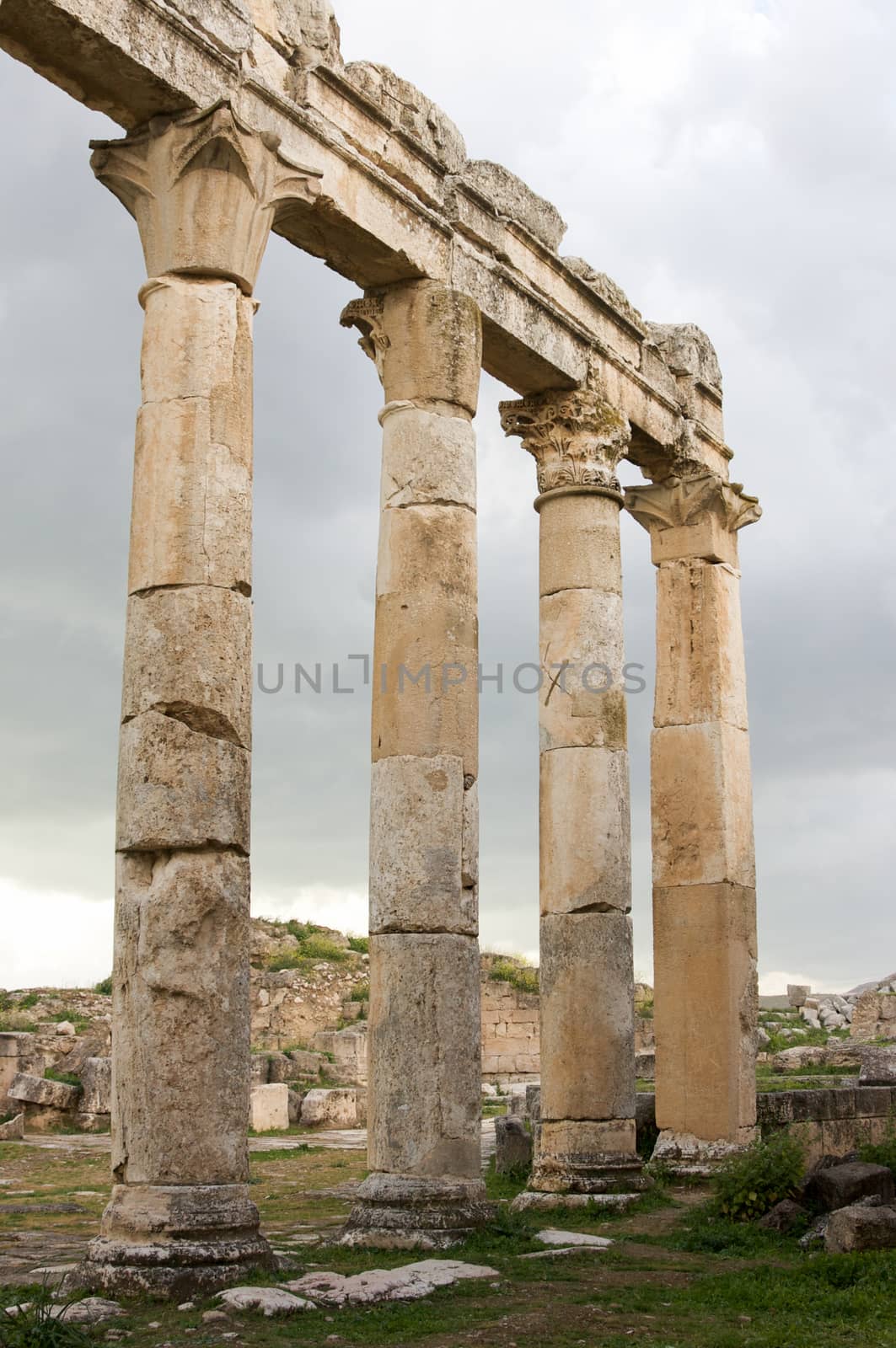 Apamea, Syria - May, 2009: Syria before the war. the Great Colonnade and triumphal arches in the impressive Apamea Greek and Roman city of Apamea in Syria. Apamea was an ancient Greek and Roman city on the banks of the Orontes River in Syria. The site includes the famous Great Colonnade, one of the longest in the world. As a result of the ongoing civil war in Syria that started in 2011, the Apamea ruins have been damaged and looted by treasure hunters.