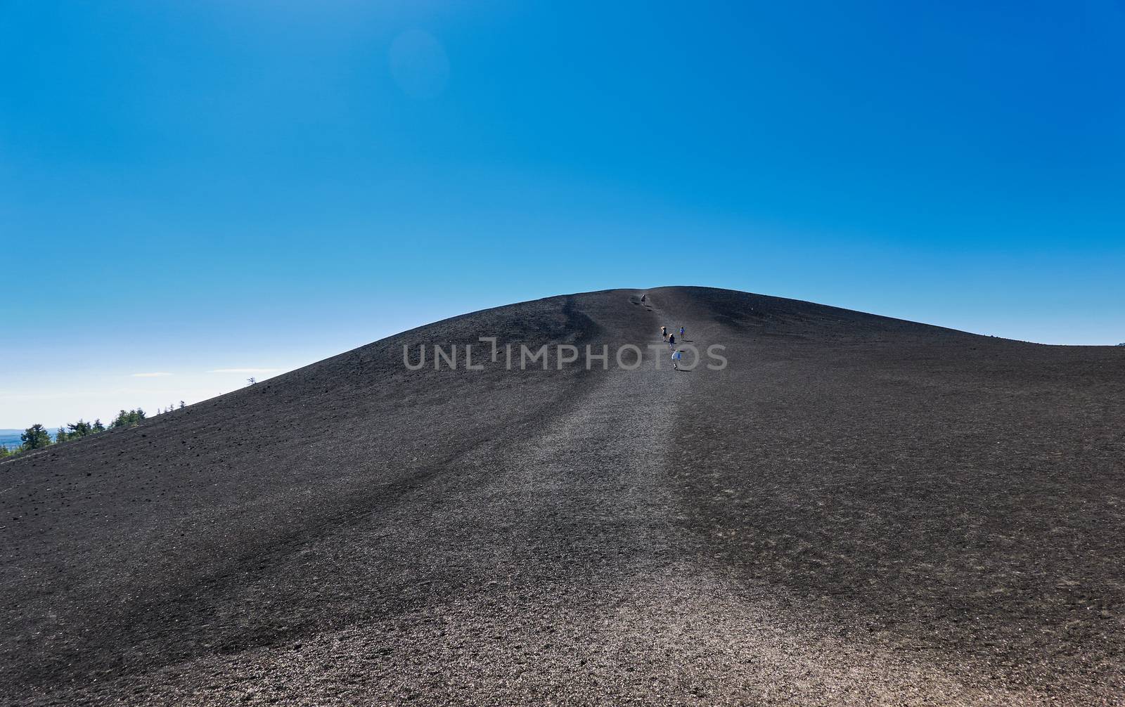 People hiking to the top of Inferno Cone at Craters of the Moon  by patrickstock