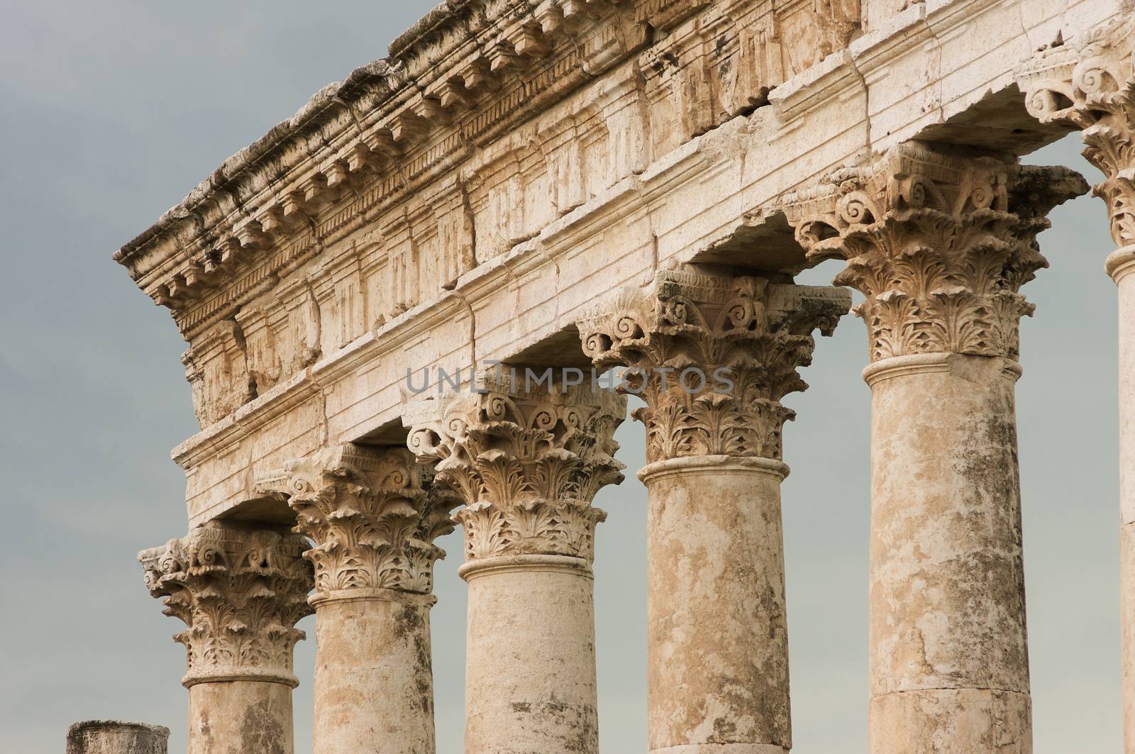 Apamea, Syria - May, 2009: Syria before the war. the Great Colonnade and triumphal arches in the impressive Apamea Greek and Roman city of Apamea in Syria. . Column tops the Corinthian order is the most ornate of the Greek orders, column having an ornate capital decorated with two rows of acanthus leaves.The site includes the famous Great Colonnade, one of the longest in the world. Because civil war in Syria that started in 2011 the Apamea ruins have been damaged and looted by treasure hunters.