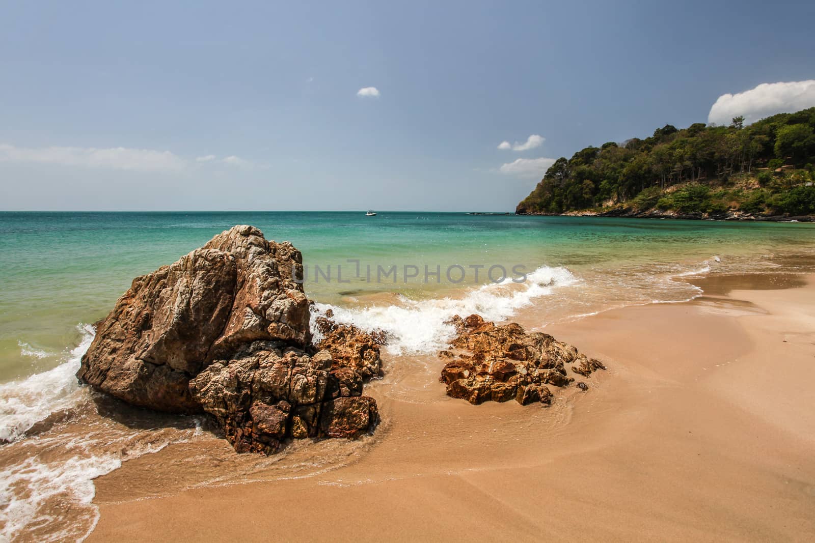 Klong Nin beach, with rocks in foreground and green blue sea in  by Ivanko