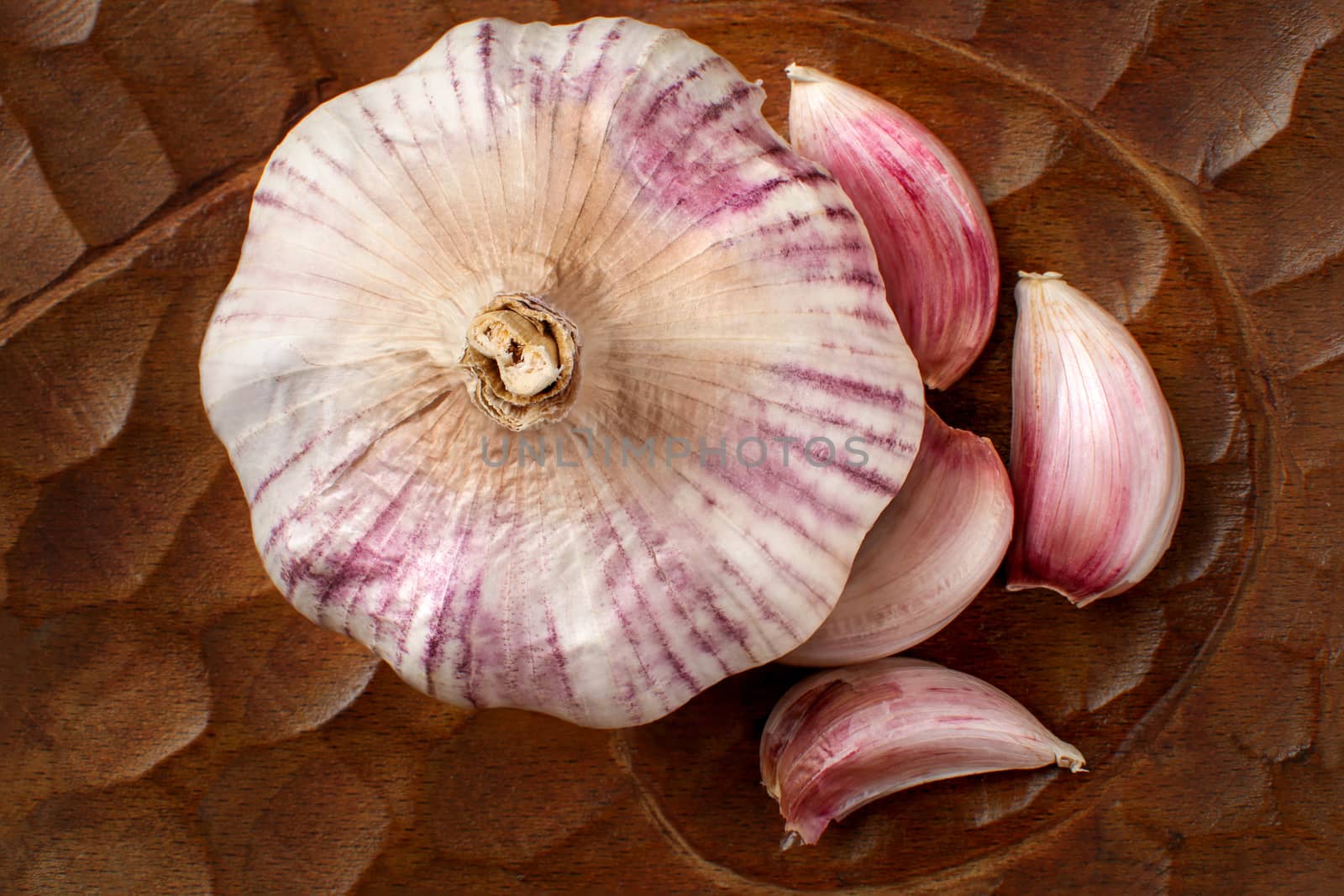 Close up view from above to garlic bulb and purple garlic cloves by Ivanko