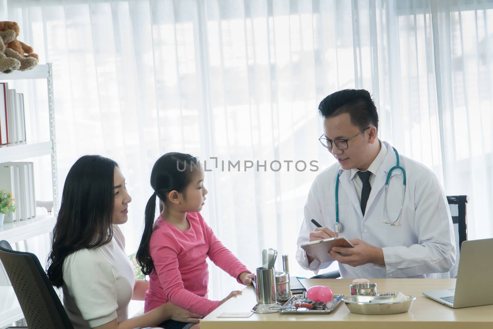 Asian adult mother and childhood daughter consult a professional doctor at the clinic. Pediatrician medical checkup Child patient And inquiring about the health. Medical advice consultation concept