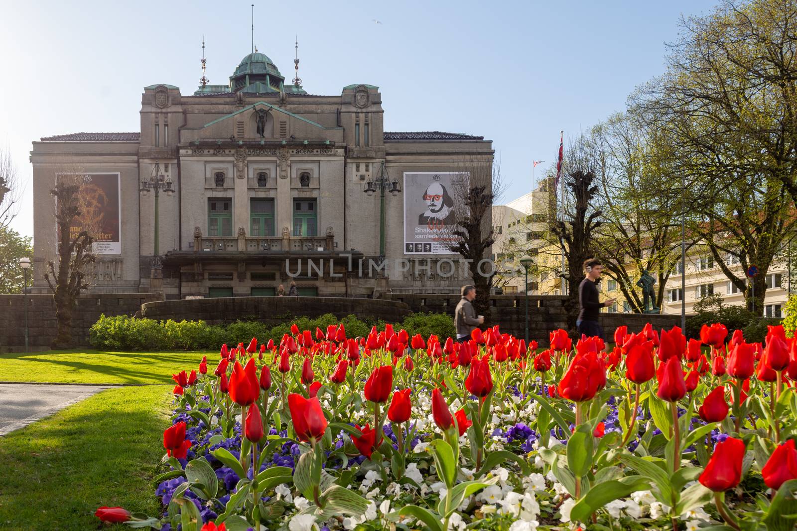 Bergen, Norway, May 2015: The National Stage, or Den Nationale Scene area in Bergen, Norway on a sunny day in spring with tulips in foreground.