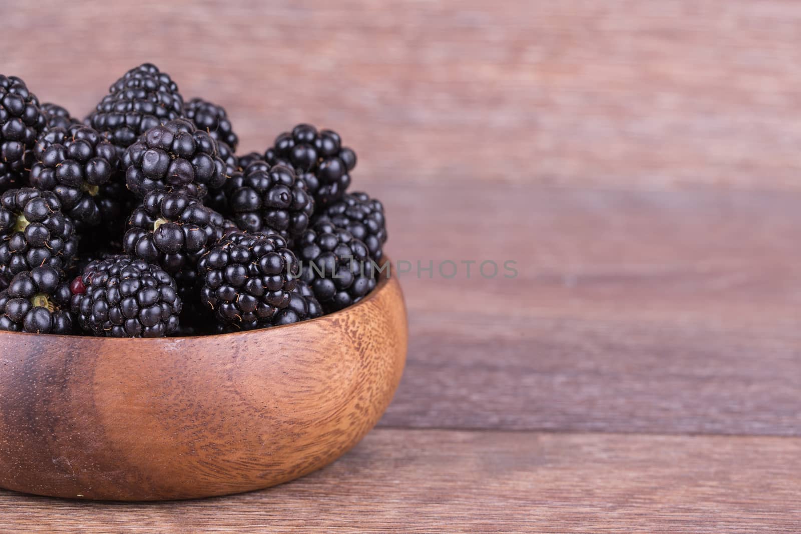 blackberries in wooden bowl  by Fischeron