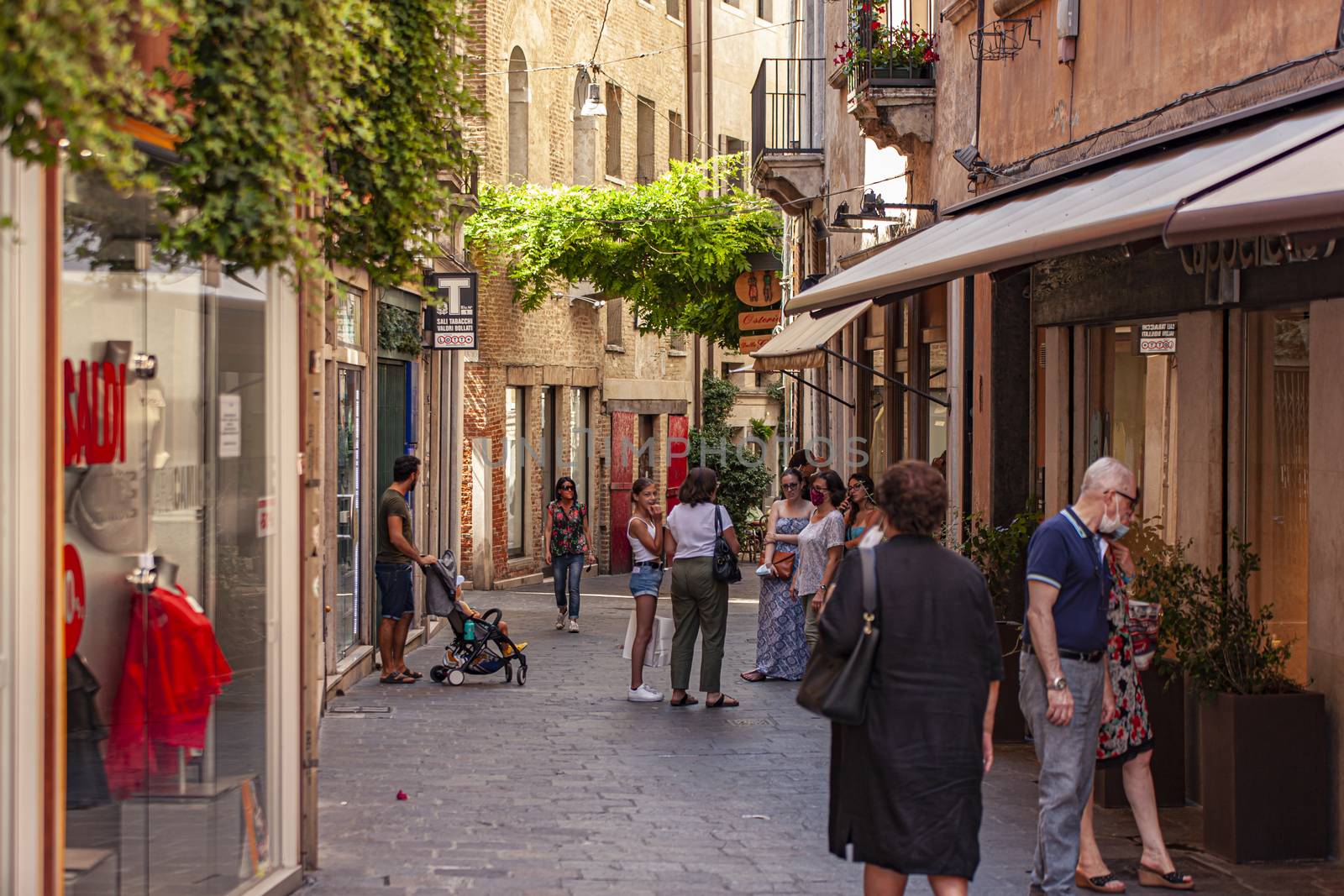 People walking in Treviso alley in Italy by pippocarlot
