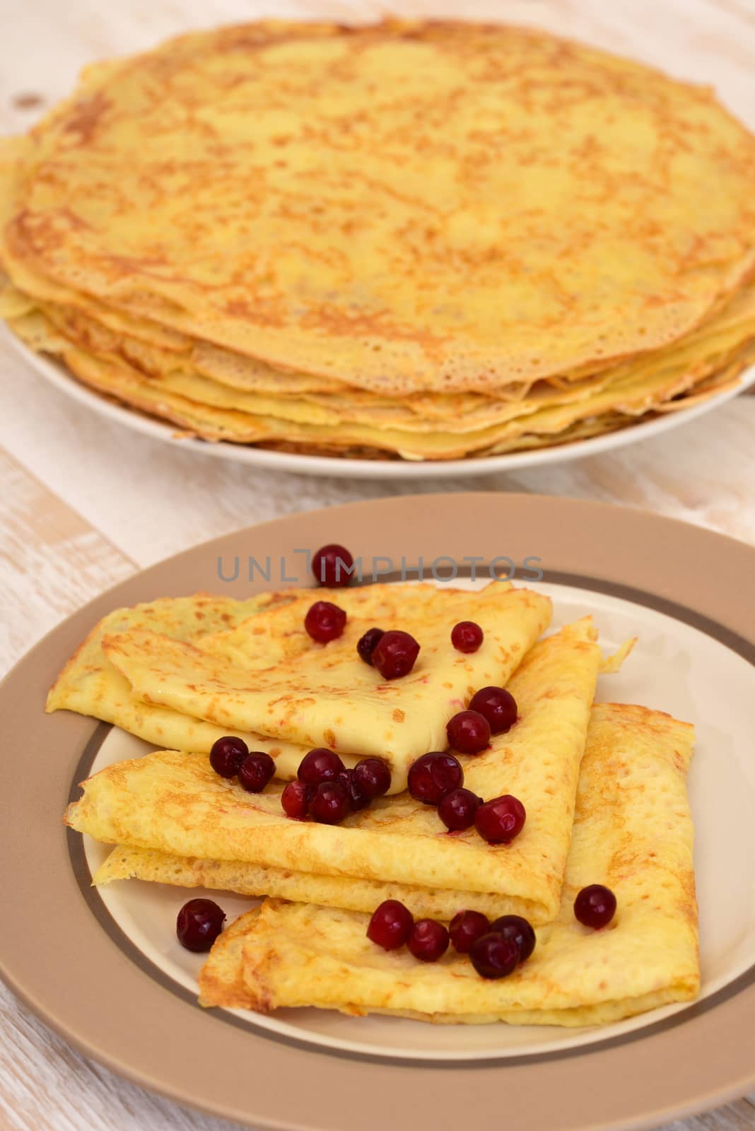 Pancakes on plate. Pancakes with berry. Traditional Russian pancakes.