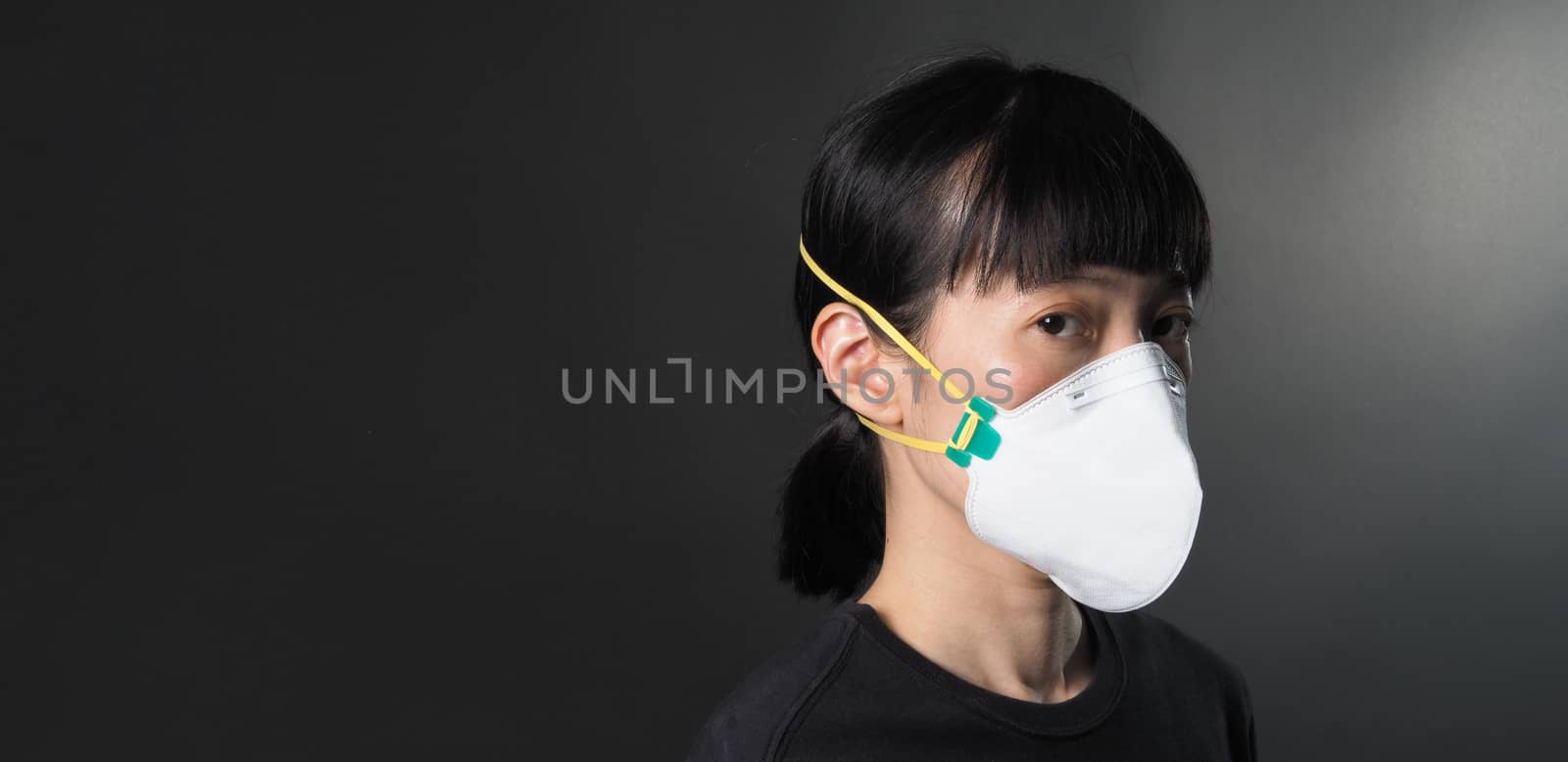 Middle aged of asia chinese woman wearing medical N95 mask  by gnepphoto