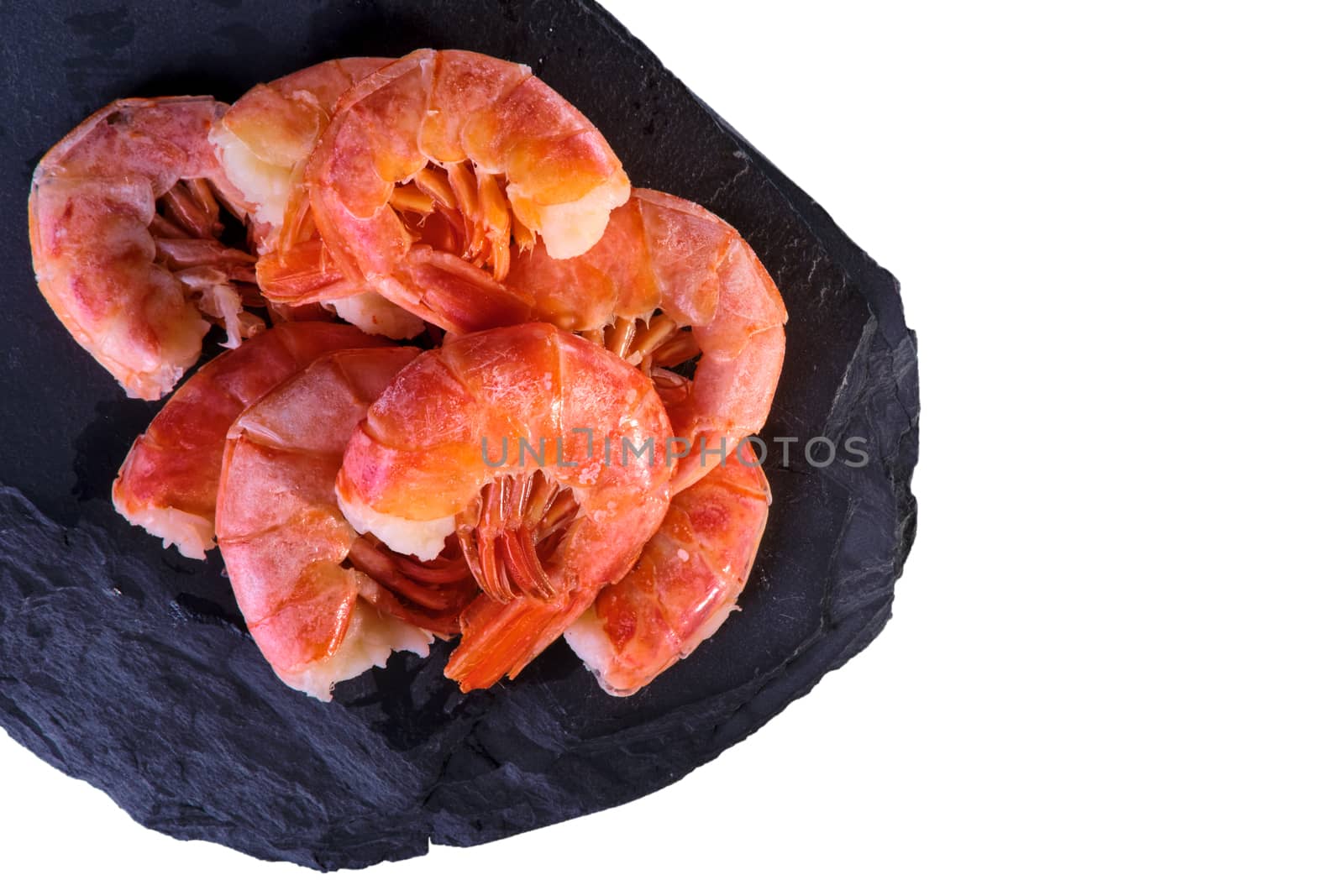 Healthy diet food: boiled wild tiger shrimps close-up on a plate on a table. Horizontal top view