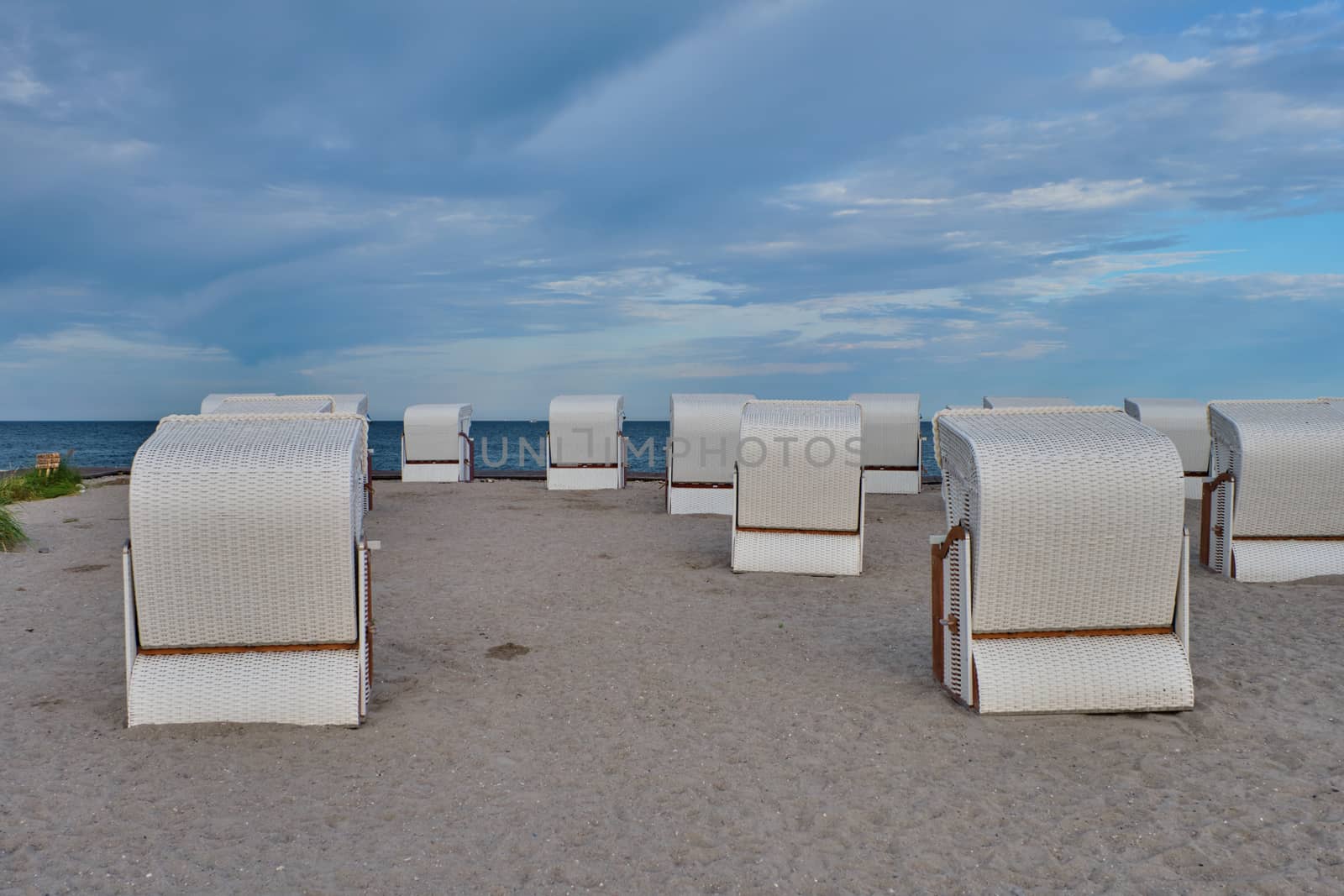 Empty beach cabins on a deserted beach at the baltic sea in the morning.