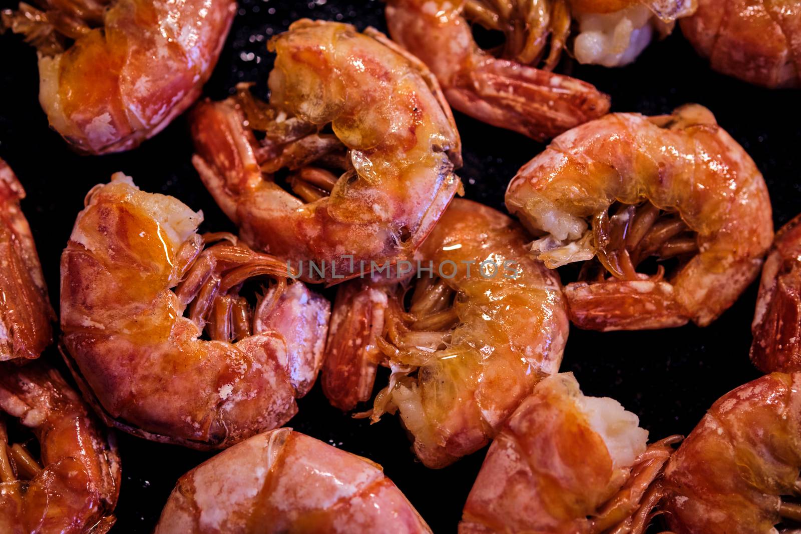 Healthy diet food: boiled wild tiger shrimps close-up on a plate on a table. Horizontal top view