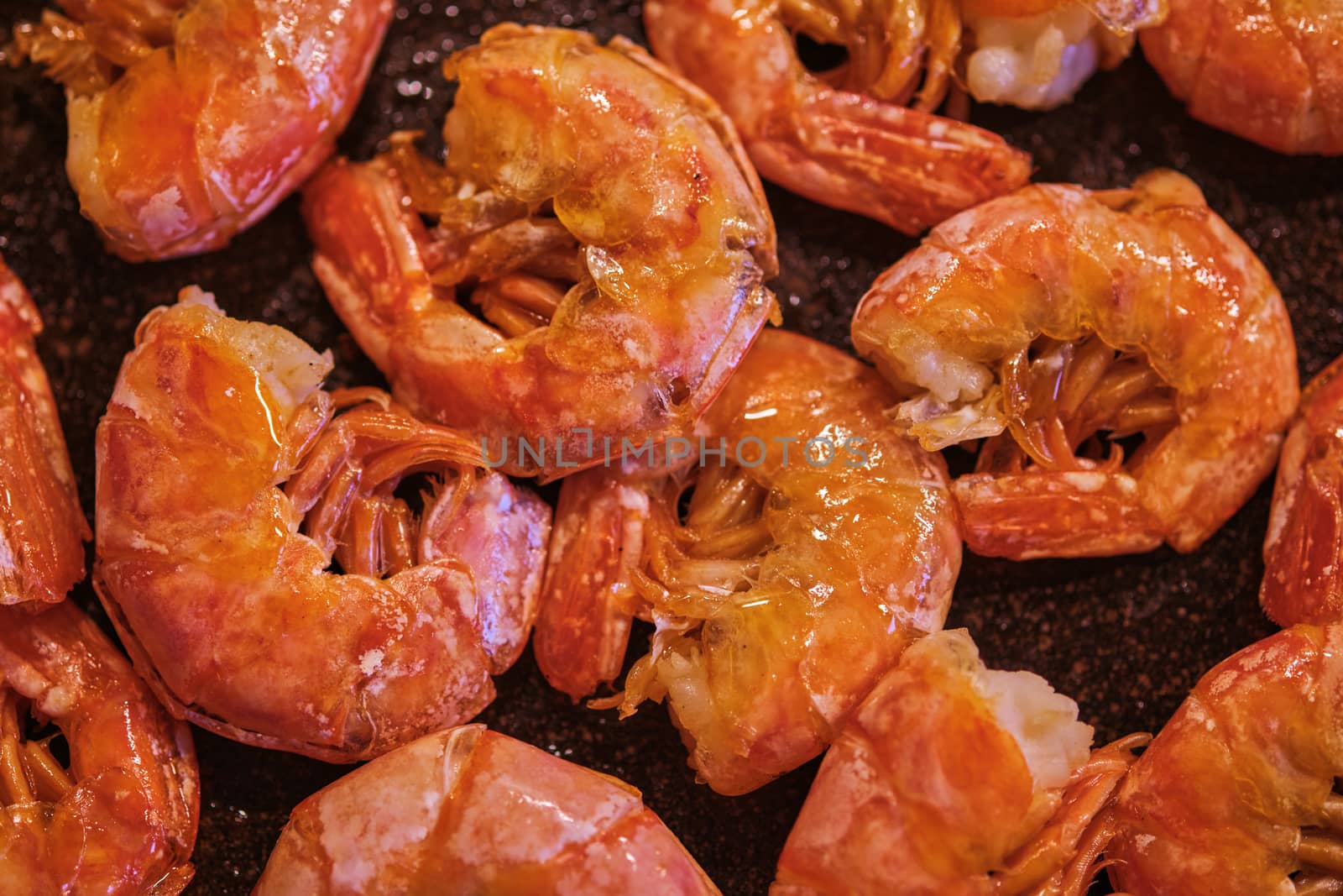 Healthy diet food: boiled wild tiger shrimps close-up on a plate on a table. Horizontal top view