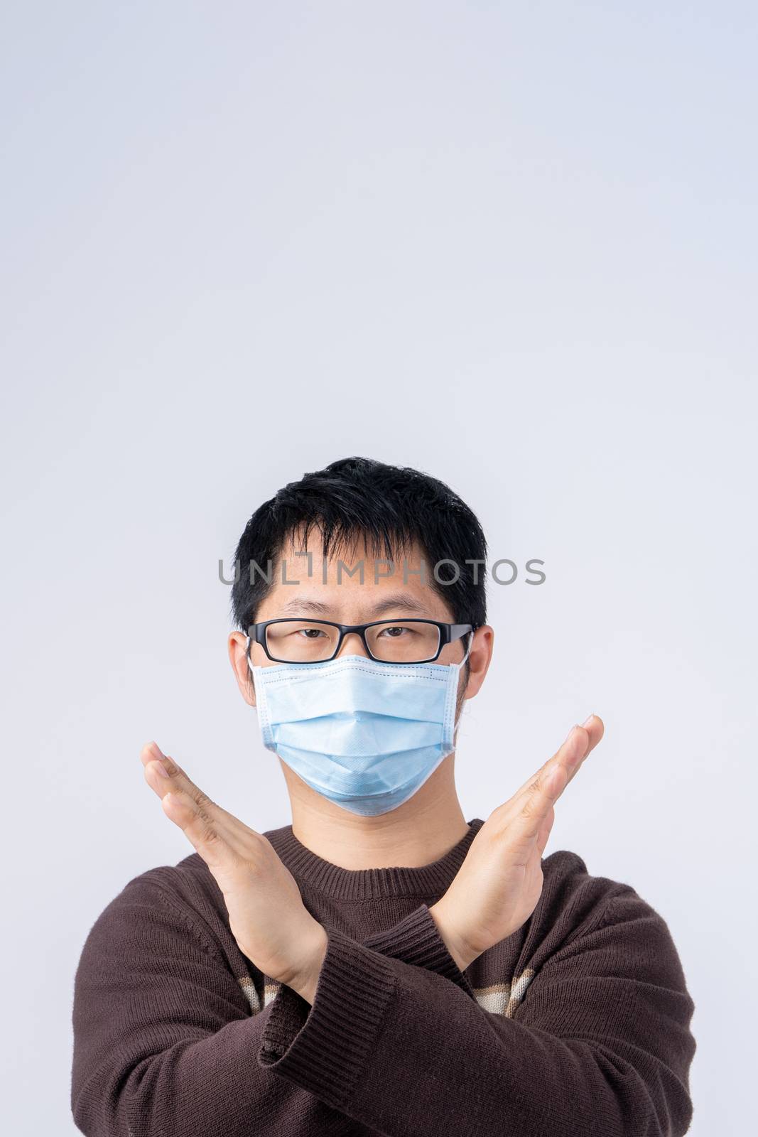 Portrait of young Asian man, saying no to coronavirus infection  by ROMIXIMAGE