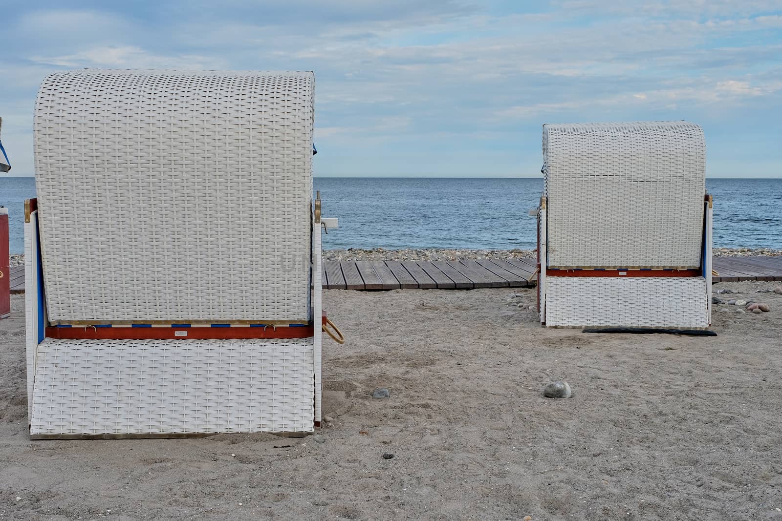 Empty beach cabins on a deserted beach. by Fischeron