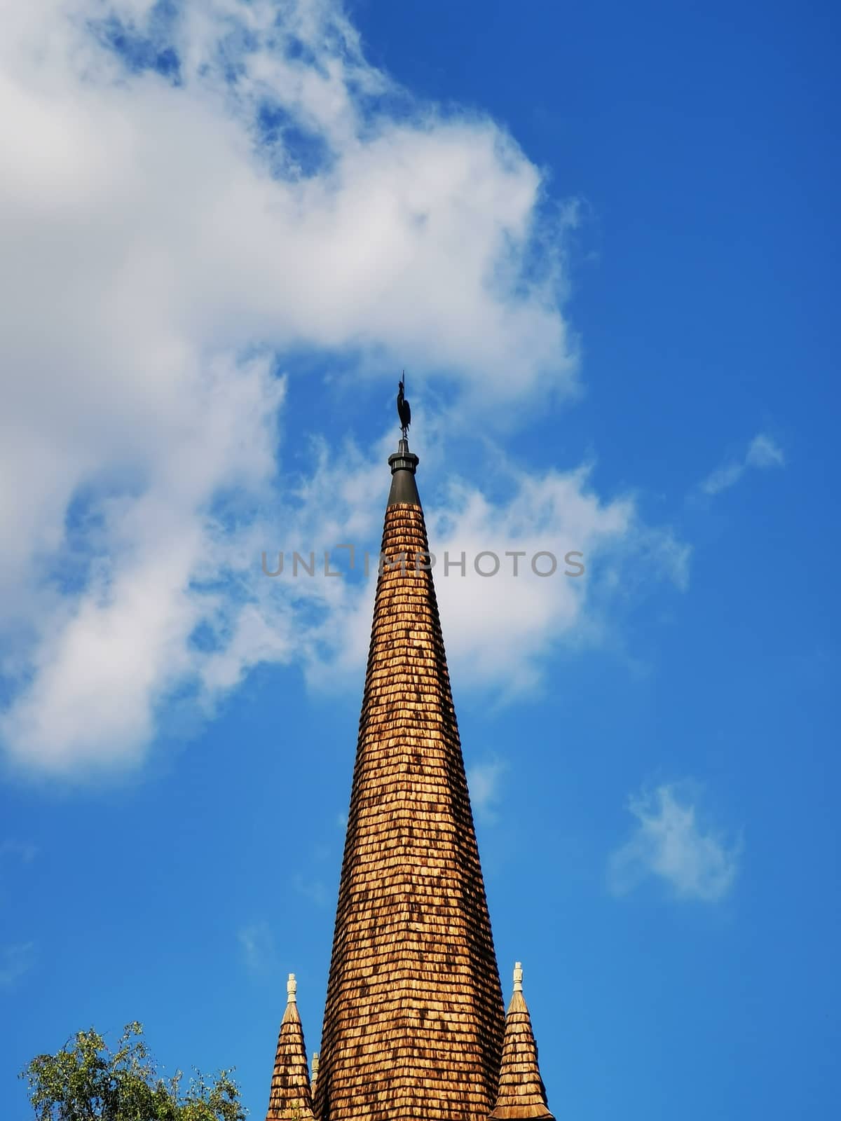 A large tall tower with a clock on the side of a building by balage941