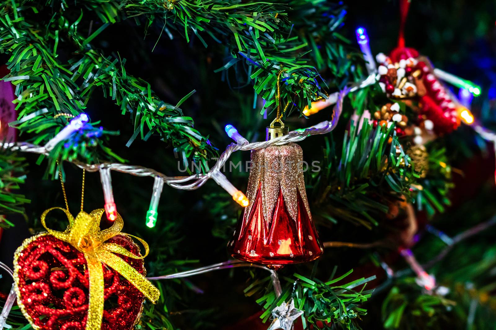 Christmas hanging decorations on fir tree. Decorated Christmas tree. Fir branch with Christmas baubles decorations.