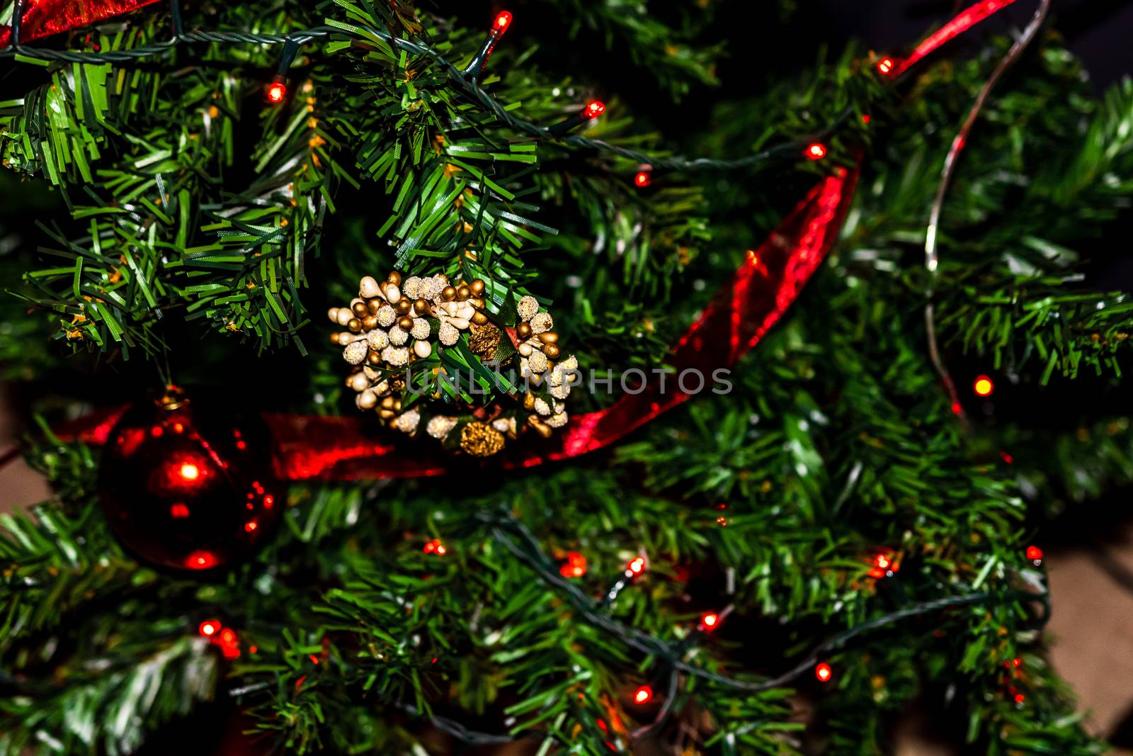 Christmas hanging decorations on fir tree. Decorated Christmas tree. Fir branch with Christmas baubles decorations.