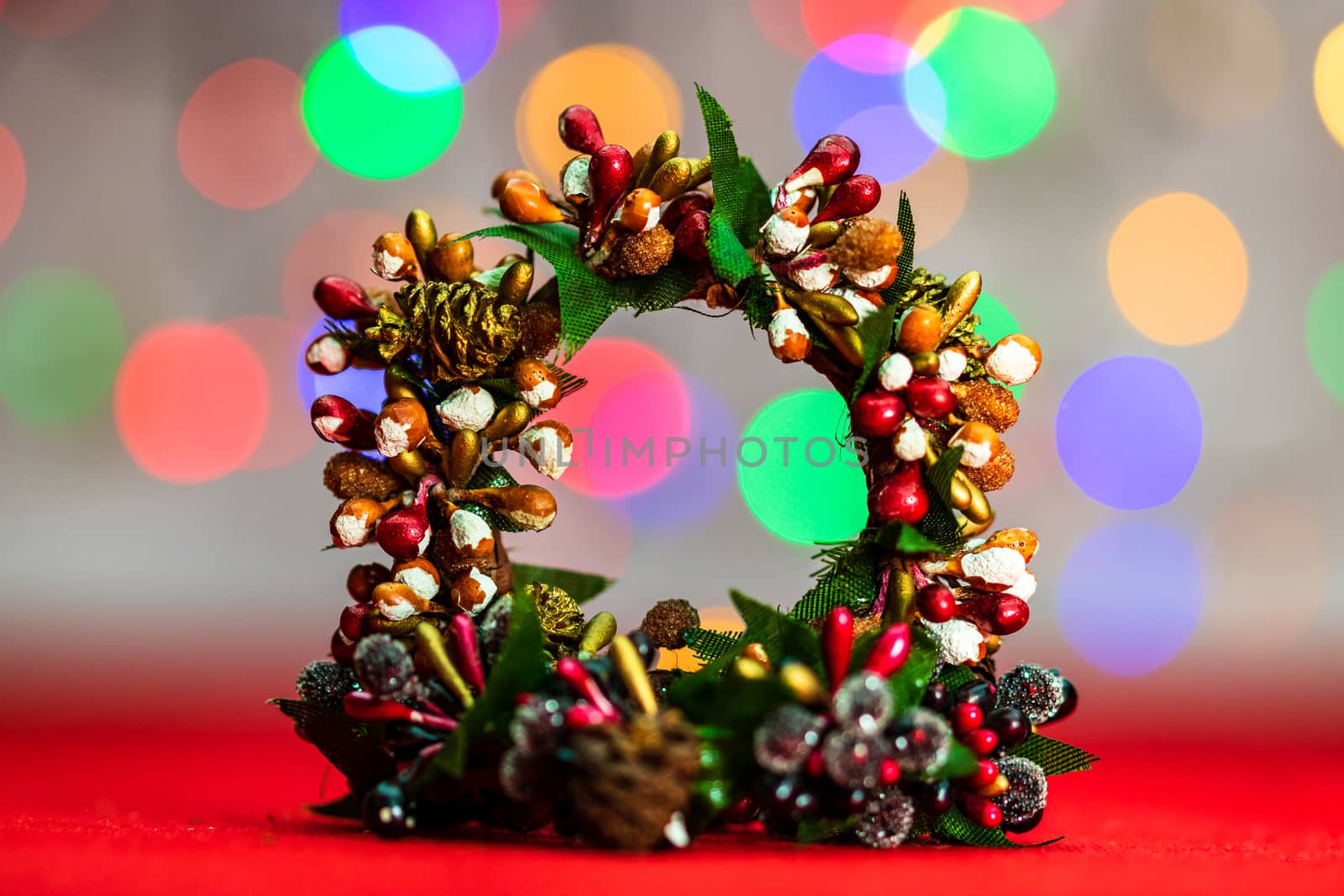 Colorful decorated Christmas wreaths isolated on background of blurred lights.