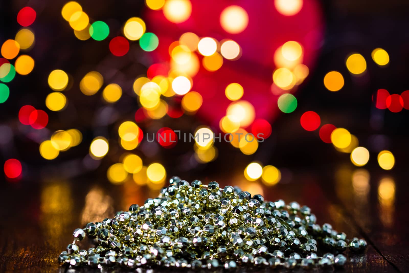 Decorations and ornaments in a colorful Christmas composition isolated on background of blurred lights.