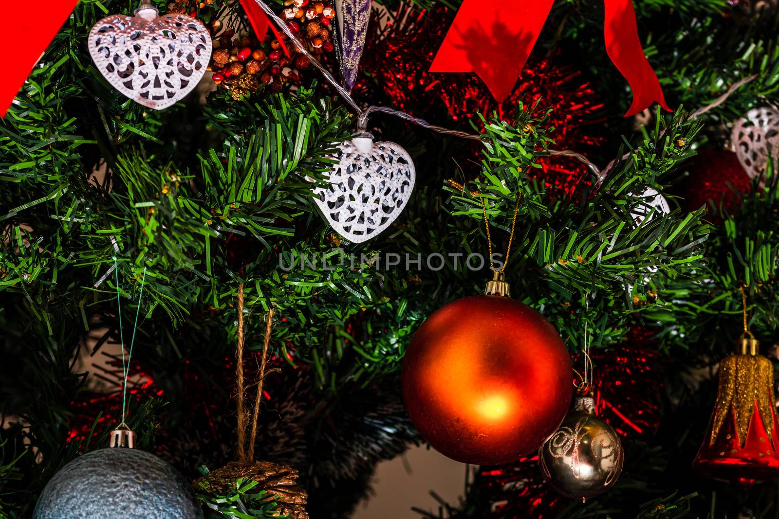 Christmas hanging decorations on fir tree. Decorated Christmas tree. Fir branch with Christmas baubles decorations.