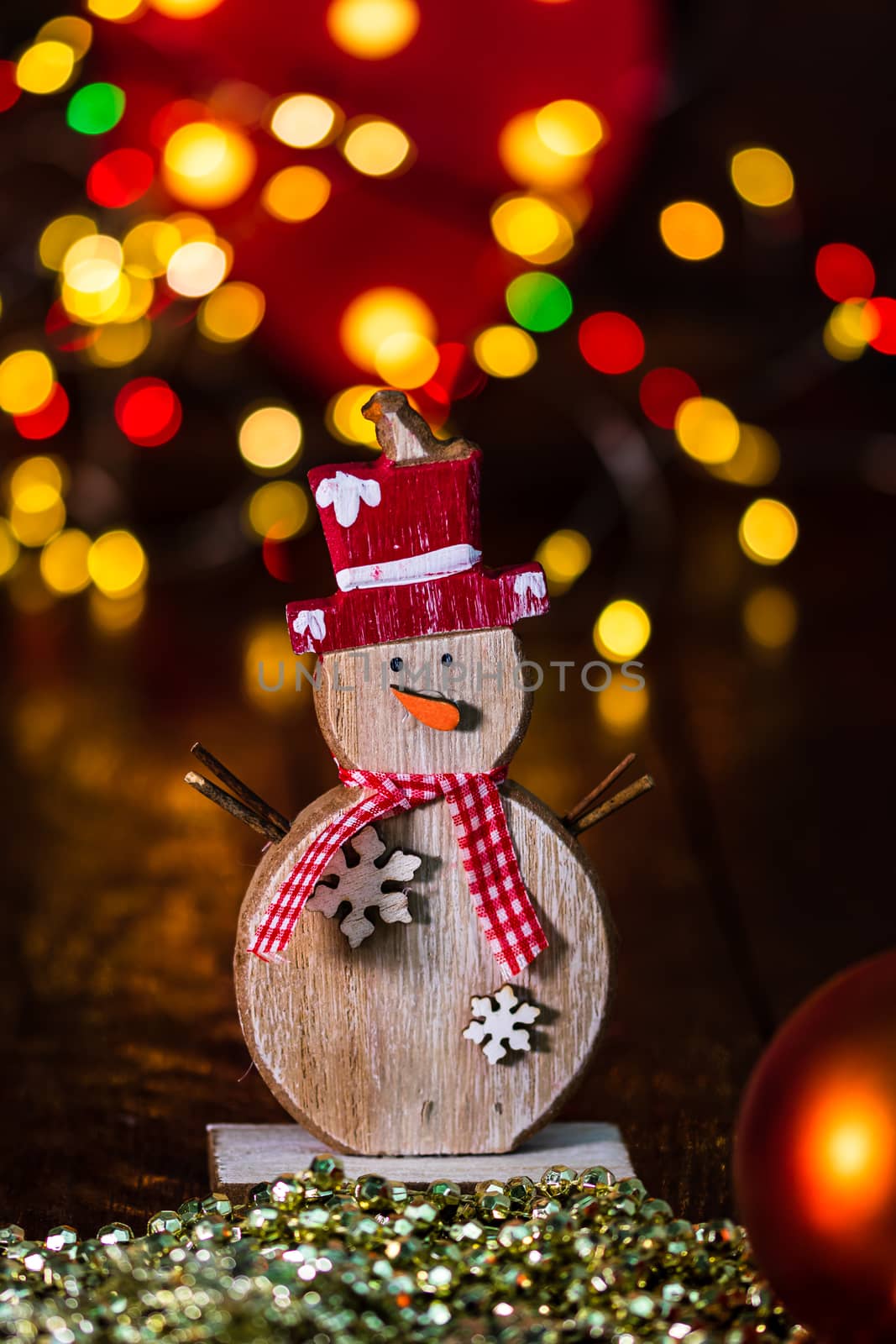Decorations and ornaments in a colorful Christmas composition isolated on background of blurred lights.