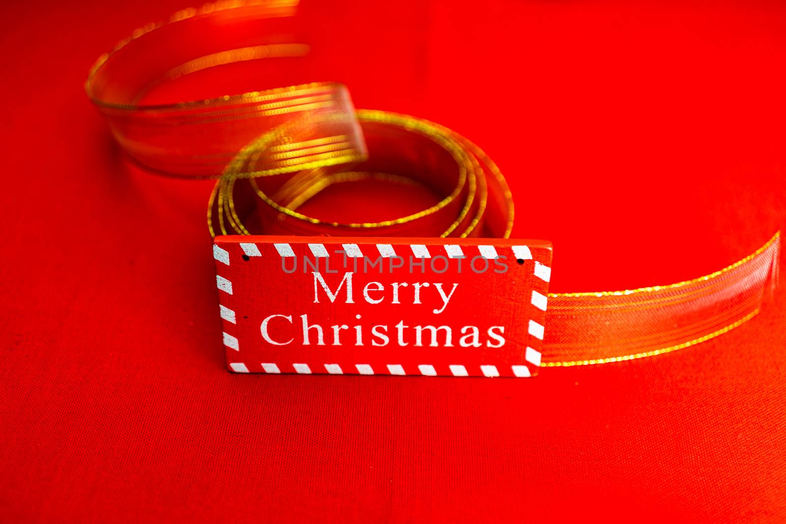 Merry Christmas text wooden sign, decorations and ornaments in a colorful Christmas composition.