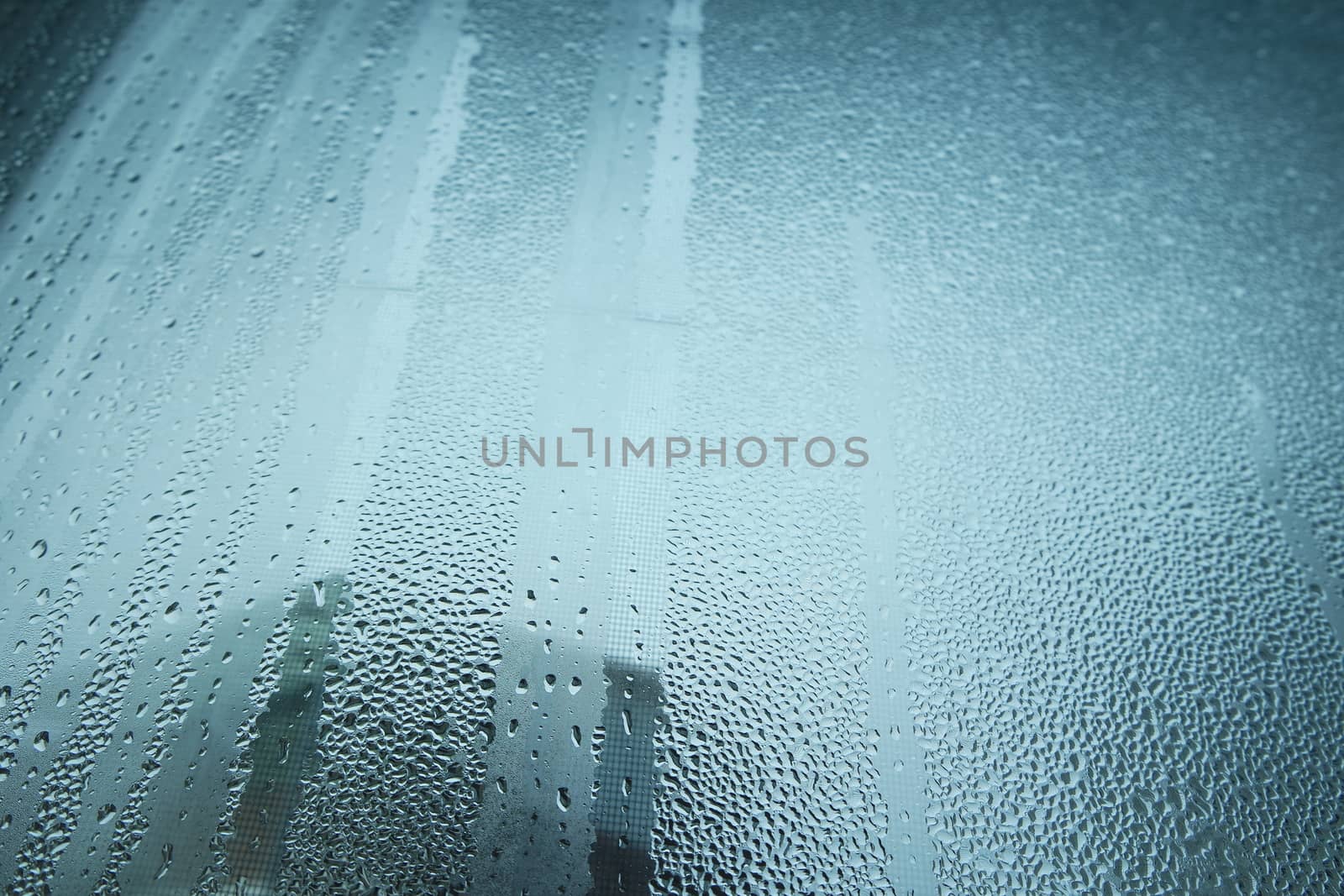 Bright grey color glassy texture, with water drops on it. Water drop glassy background