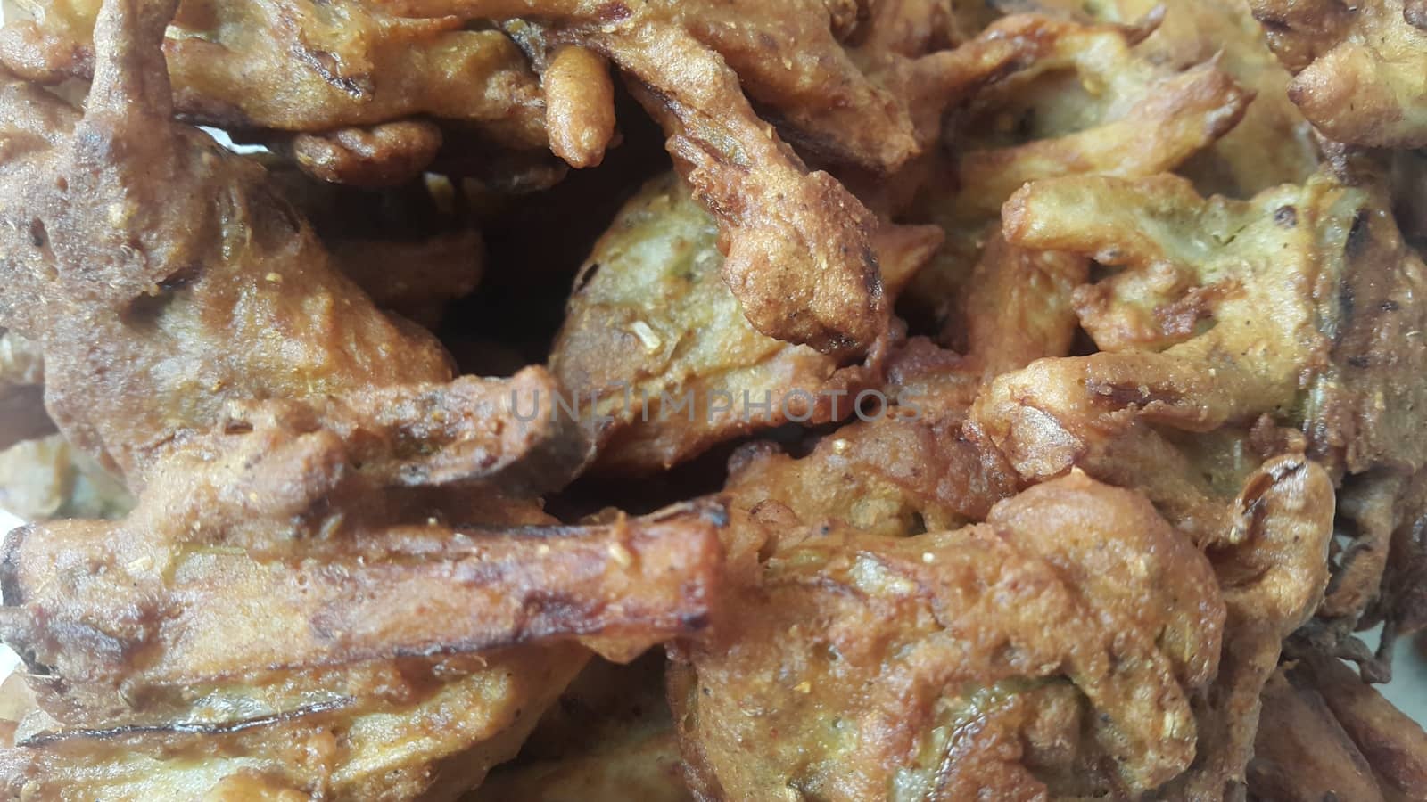Crispy basin pakora/pakoda or patties are popular indian or pakistani street food snack, served with green salad and sauce. Selective focus of