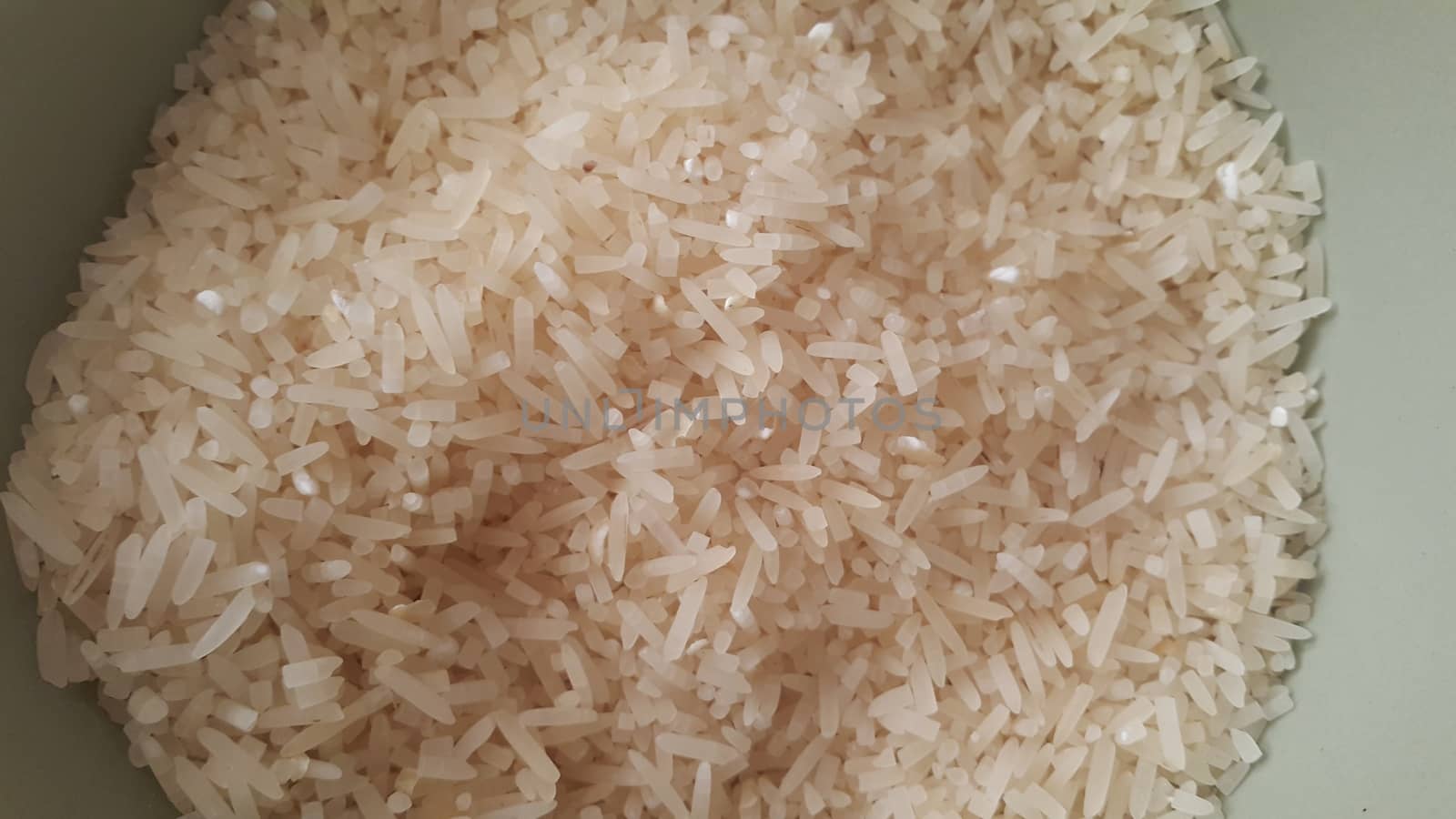 Top closeup view of heap of rice. Rice is the most consumed food ingredient in the world