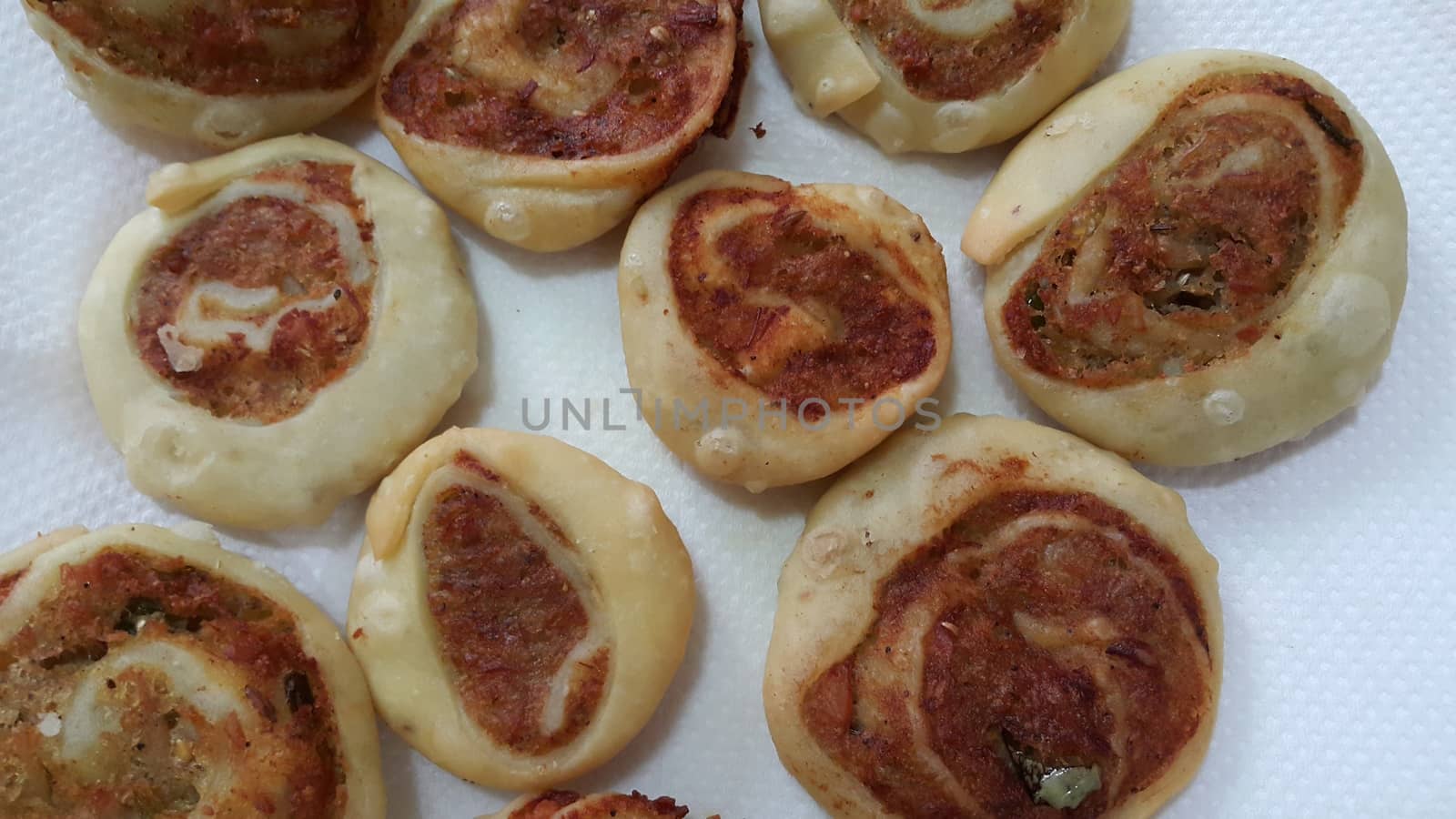 Closeup of delicious home made pinwheel puff pastries food item placed over white background