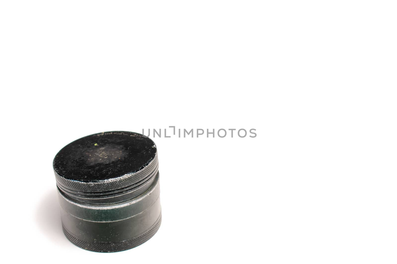 A Used Black Cannabis Grinder With the Lid Slighty Ajar by bju12290