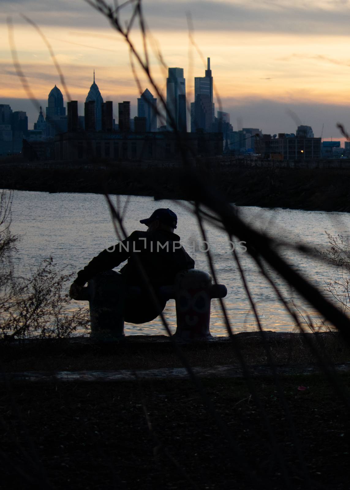 A Man Leaning on Two Poles At Graffiti Pier by bju12290