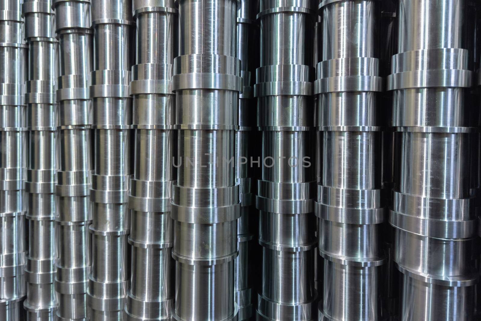 abstract industrial shiny steel production stack full frame background with cnc machined pipes - selective focus and lens blur technique by z1b