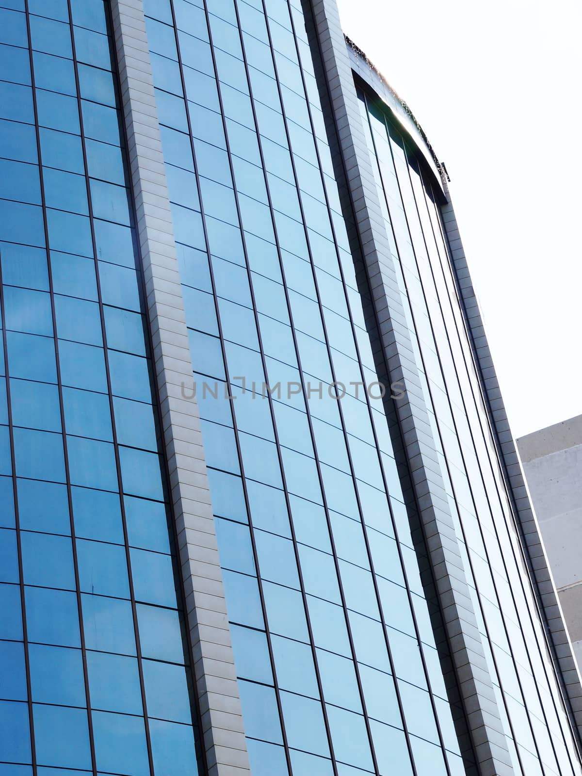 fragment of the glass facade of a skyscraper by Annado