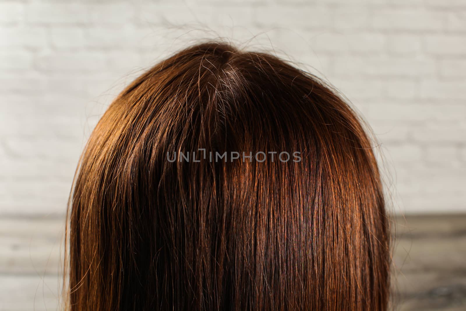 Detail on natural dark brown woman hair see from behind. by Ivanko