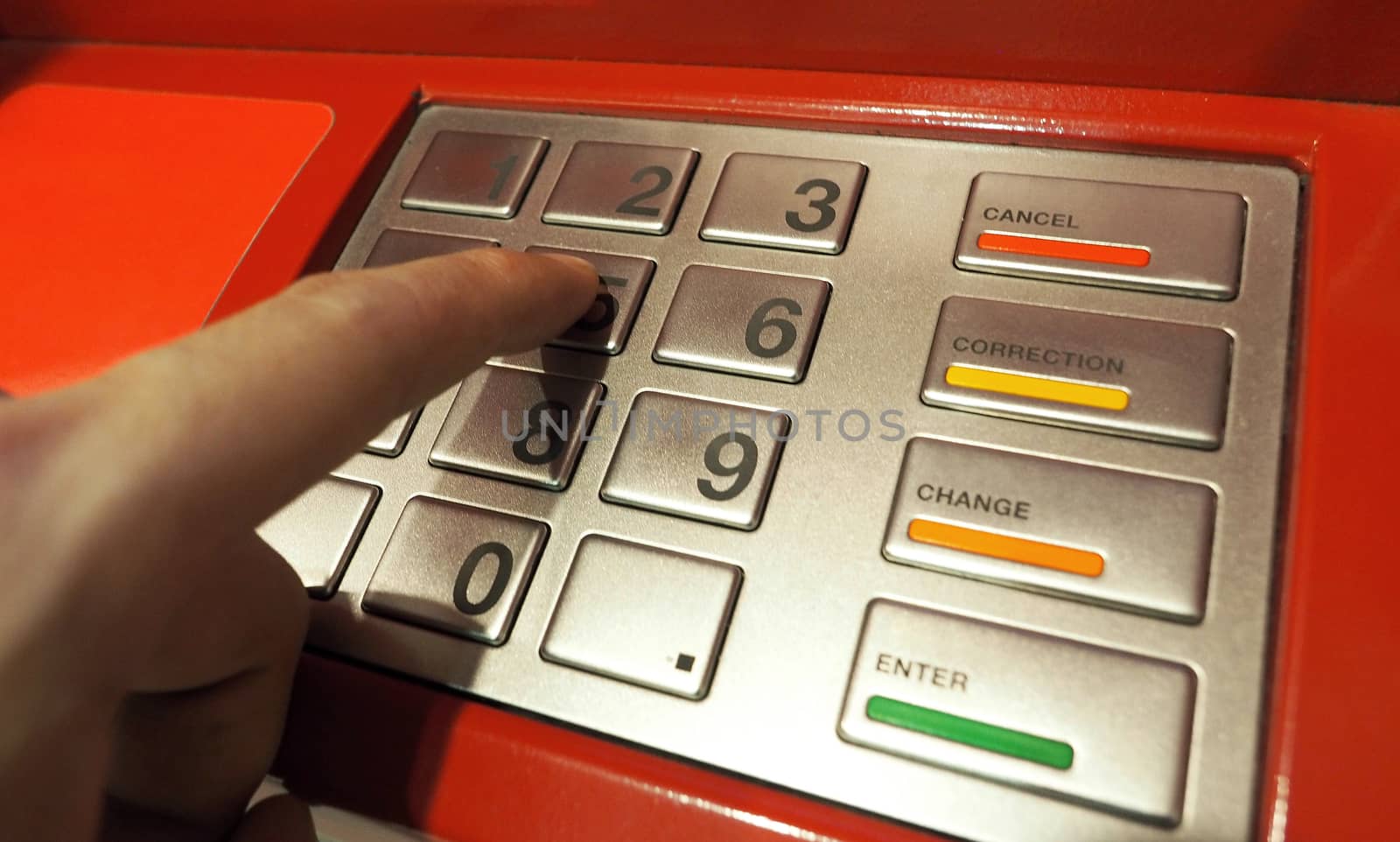 ATM pin button close-up and human hand index finger. by gnepphoto