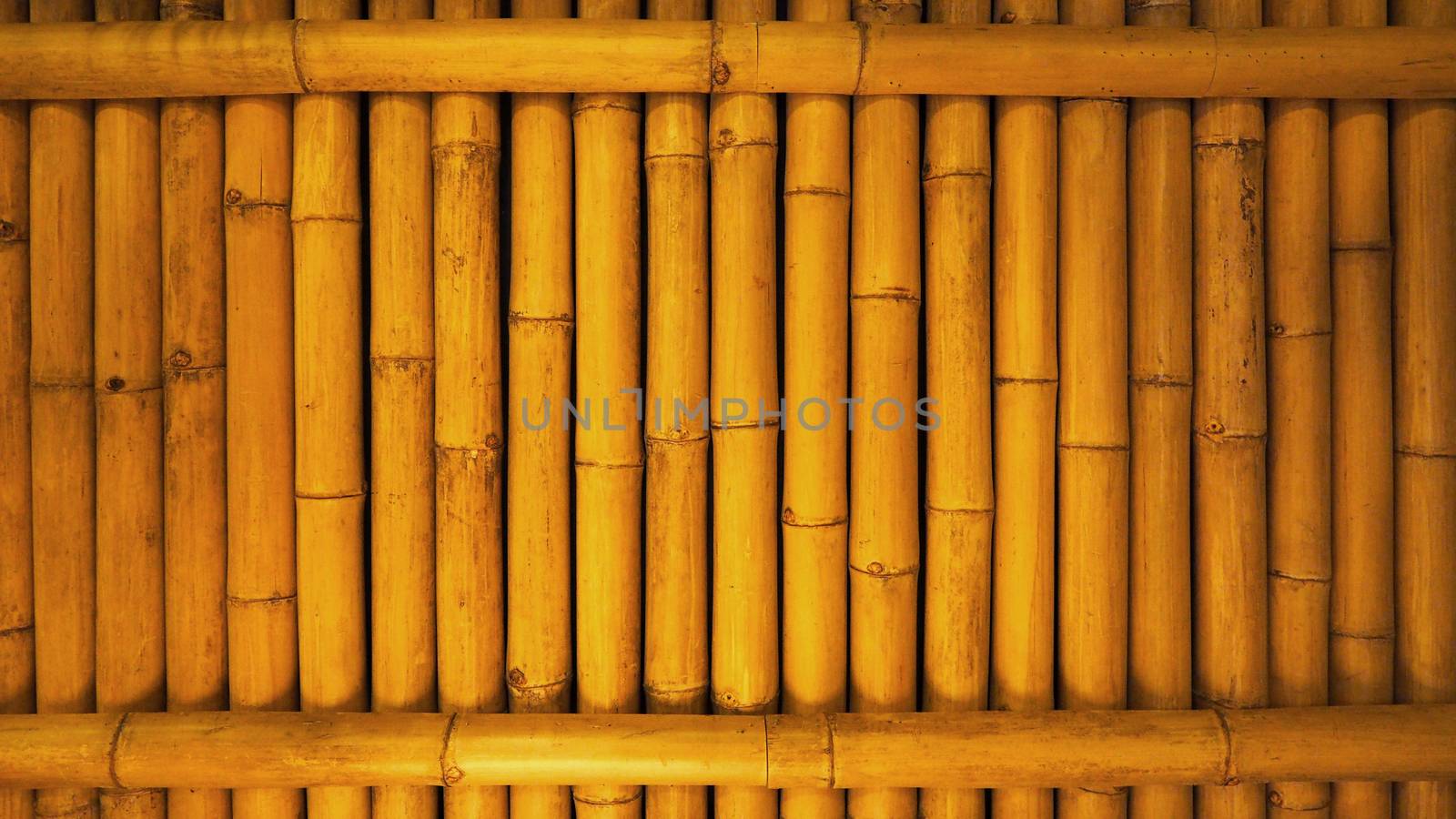 Old dirty bamboo background wall from real nature to home decor interior and light on for texture and japanese style.
