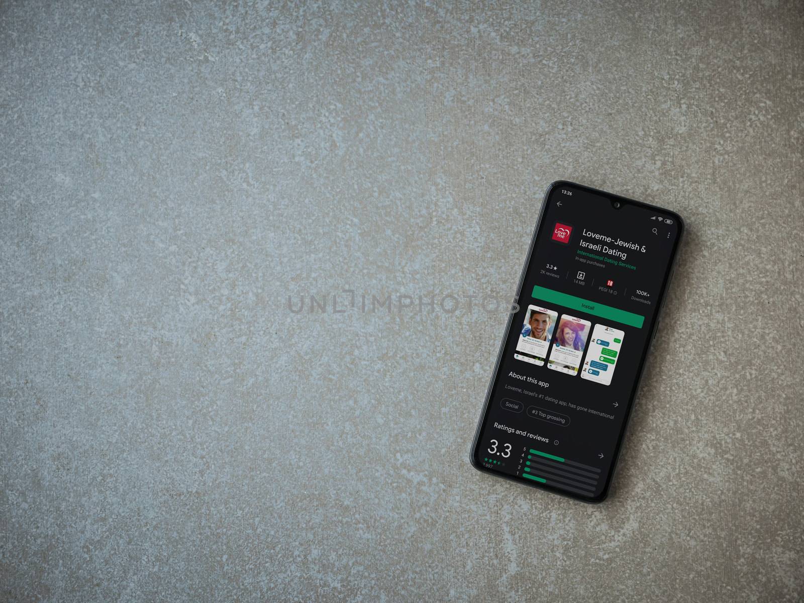 Loveme app play store page on the display of a black mobile smar by wavemovies