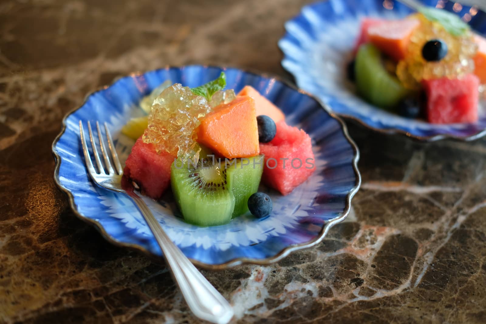 mixed fruit papaya kiwi blueberry watermelon orange in blue dish